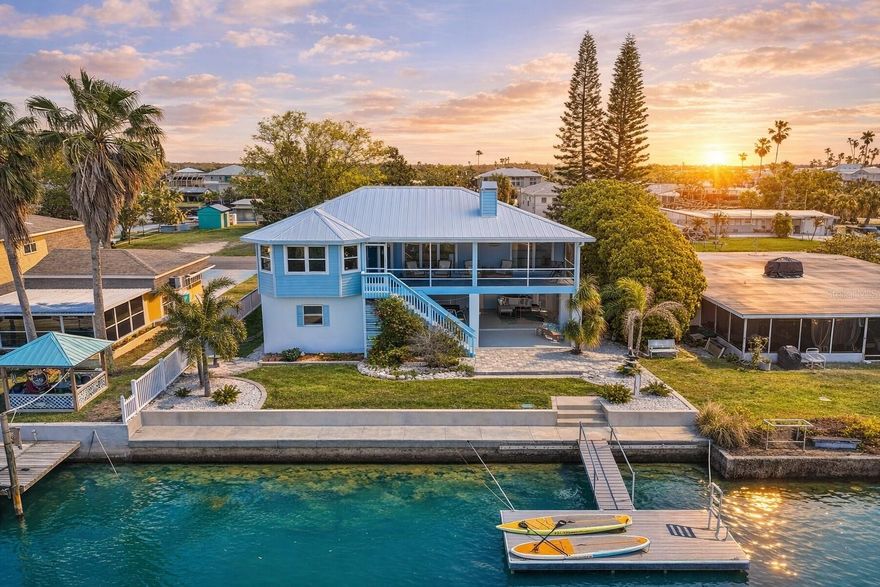 Coastal Waterfront Living with Beautiful Western Sunset Views awaits at 4475 Burmuda Drive in Hernando Beach. Direct Quick Access to the GULF. Completely Remodeled with Luxury finishes, this Stunning Home offers 3 bedrooms plus an Office, 3 full bathrooms, a 2-car garage, and a huge 420 sq. ft workshop for hobbies, storage, or projects. Inside, The Living Room impresses with Vaulted Ceilings, a Stone Wood-Burning Fireplace, and 2015/2016 New impact Sliding Glass Doors that bring in Natural Light and Frame the Waterfront Setting. Right off the Living Room is the beautifully Redesigned Kitchen which is a Showpiece, Featuring Quartz Countertops, Wood Cabinetry with Soft-Close Features, pull-out drawers, 2 lazy Susans, pot drawers, a custom silverware drawer, and a Navy Blue Large Island / Breakfast Bar with Additional Cabinets underneath topped with Beautiful Quartz Counters for casual dining and entertaining.. The kitchen also offers 2 built-in Pantries, in-cabinet and under-cabinet Lighting, Pendant lights, and Modern Stainless Steel Appliances with Chimney Vent. The primary suite is a peaceful retreat with sliding glass doors to the back deck, a huge walk-in shower, and a beautifully remodeled en-suite bath with dual sinks and wood cabinetry with stone counters. Two additional bedrooms and remodeled guest bathrooms are privately tucked away from the primary suite, offering comfort and separation for family or guests. The office enjoys a beautiful water view, creating the perfect space to work or relax. Outside, the Back Deck overlooks the Water and 8x20 Floating Dock, with room to add a Future Pool. Waterfront improvements include a 2023 seawall, braced seawall, and knee wall. For added buyer confidence and insurance appeal, the seller is offering a NEW 3-DIMENSIONAL ROOF prior to closing, and the buyer can choose their own roof color. Additional recent updates include a 2026 water heater, 2026 HVAC, and a 2024 Impact-Resistant Garage Door, making this Coastal retreat as practical as it is Beautiful. PLUS $1,116 Per YEAR for NFIP ASSUMABLE FLOOD INSURANCE POLICY. Enjoy the Best of Florida Coastal Living in Hernando Beach, where Waterfront Charm, Direct Gulf access, and Stunning Sunset Views create the perfect place to call home. This Unique Boating Community offers a Relaxed Lifestyle with easy access to Fishing, Kayaking, Local Marinas, and Favorite Waterfront Dining Spots. From Scenic Canals to the Nearby Natural Beauty of Weeki Wachee and the Gulf, Hernando Beach gives future homeowners the ideal mix of Recreation, Tranquility, and Everyday Paradise.