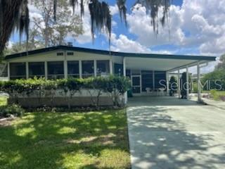 Spacious property with much to offer, such as the burnable fireplace. Partly furnished allows you to move forward and start living the Florida life style of enjoyment. So much to do in our community, activities galore if you want to attend or just relax pool side, if your the energizer bunny, we have a bunch that live here and its hard to keep up. The rooms are larger with large additional space on side which includes screened Florida room with work shop, laundry area and large area for 2 golf carts, one is included but needs new batteries. The yard is landscaped so you can enjoy the tropical setting. Short distance to golf course, pool, restaurant and when you want a change of scenery, 3 miles to Brownwood in The Villages where you will find nightly entertainment, more restaurants and shopping. We're central Florida, 35 min. north to Ocala, 1 hr south to Orlando, and 1 hr. east or west to the beaches. You will love it here, I know because I live here and love it.