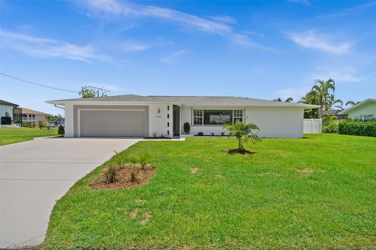 Welcome to 4419 SE 13th Pl, a beautifully renovated Gulf Access pool home located just minutes by boat from the river, restaurants, beaches and the Gulf! Situated on an oversized .34-acre lot with 110 feet of waterfront, this property offers expansive outdoor space and quick boating access. A composite dock and 10,000 lb boat lift make it easy to enjoy the best of Southwest Florida’s boating lifestyle. The interior is bright and modern, with recessed lighting throughout. The kitchen is a features a large island with quartz waterfall countertops, breakfast bar seating, walk-in pantry, and brand-new stainless steel appliances, including a wine fridge. The space flows into the living and dining areas, and it all overlooks the pool and canal, making it ideal for entertaining. The primary suite opens directly to the lanai and includes a walk-in closet and an ensuite bath with double vanities and a glass-enclosed walk-in shower with rainfall head. The second bedroom also features an ensuite bath. The 3rd bedroom has sliding doors directly to the Lanai, and the fourth bedroom has lots of windows for tons of natural light. A third full bathroom doubles as a pool bath. The large lanai and pool area are finished in travertine pavers, extending into a walkway that leads to the dock. Whether you're relaxing poolside or watching the sunset from your backyard, this home was designed to maximize outdoor living. Additional features include electric roll-down hurricane shutters around the entire home, a two-car attached garage, and a washer, dryer and laundry sink. This move-in ready home offers a rare combination of space, style, and location in one of Cape Coral’s most desirable neighborhoods.