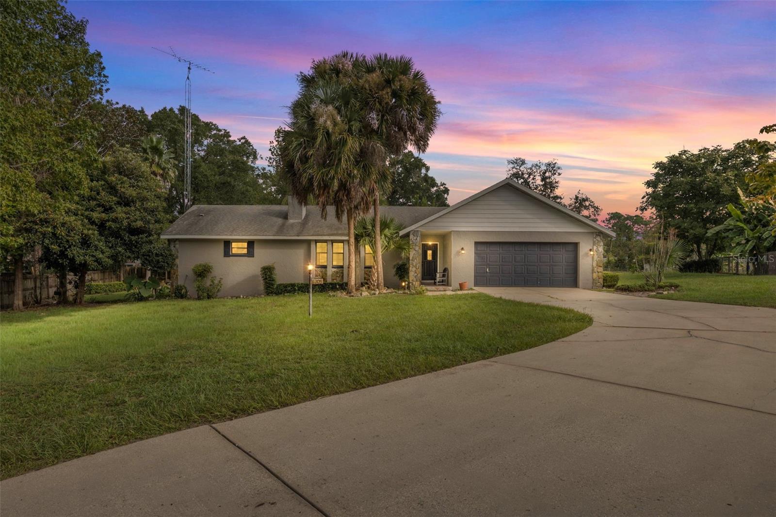 Beautiful block home on an oversized, .68 ac. lot, in a desirable non-HOA community. This well-maintained property features a large screened pool with a spacious lanai showcasing hand-cut mosaic tile, plus a private patio off the Primary suite. Enjoy multiple access points to the pool area with three sliding doors, and a convenient cabana bath. Inside, the split floor plan offers 3 bedrooms with walk-in closets, including an oversized Primary suite with dual sinks, a separate vanity area, and a step-down walk-in shower. The home offers both a large formal living room and a large family room with skylights, built-in shelving, and a stone fireplace. Recent updates include a new drain field and septic service (2025), pool equipment and heat pump (2022), and a serviced well pressure valve (2025). Additional features include an extra-long double driveway, 2-car garage with side man door, shed, blinds and drapes, ceiling fans in all rooms, and mature landscaping with palm trees. Security system owned; monitoring optional. Furniture available. HVAC annual checkup done 8/23/25.