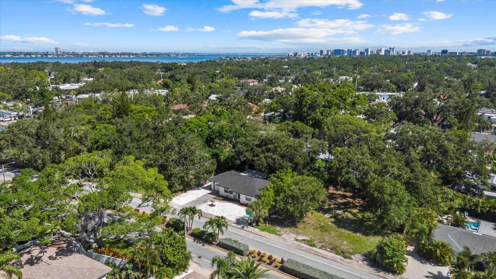 Opportunity knocks in one of Sarasota’s most desirable locations! Situated just over the North Bridge and only one mile to the world-famous Siesta Key Beach, this charming 2-bedroom home sits on just under a 1/4 acre lot with NO HOA or deed restrictions. Whether you’re a first-time buyer wanting that coastal lifestyle, or an investor seeking your next high-potential property, this checks off all the boxes. What makes this opportunity even more compelling? The vacant lot next door is also available as a package deal, offering the possibility to build your next coastal retreat. With a flexible open floor plan inside, a 2025 roof, and a spacious backyard ready for a pool, ADU or complete redevelopment, making this a rare find in such a prime location. With top-rated schools, shopping, dining, and the beach all within minutes, 1857 Siesta Drive is the blank canvas you’ve been waiting for.