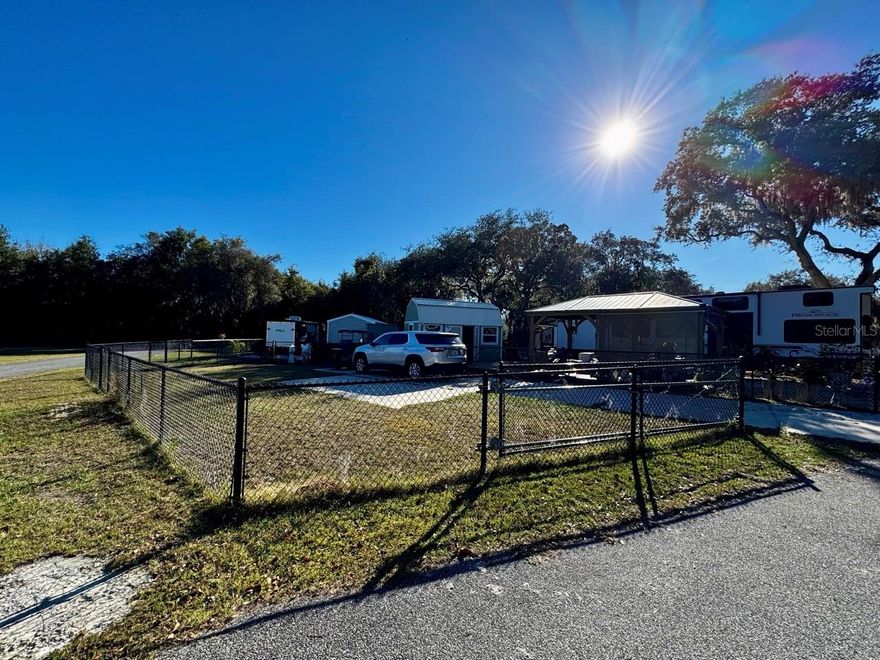 Vacant lot, ready for your unit in Lake Ocklawaha RV Resort! Lot 56 has an RV pad with an additional 12' x 45' slab, and perimeter chain-link fencing added in 2023. Association amenities include a Jr Olympic-sized pool, community building, laundromat, restrooms/showers, playground, dog park, volleyball pit, fire pit, cornhole, beach area, access to forestry ATV riding/hiking trails, and picturesque views of Lake Ocklawaha! Would make a great full-time residence, seasonal retreat, or investment opportunity!
