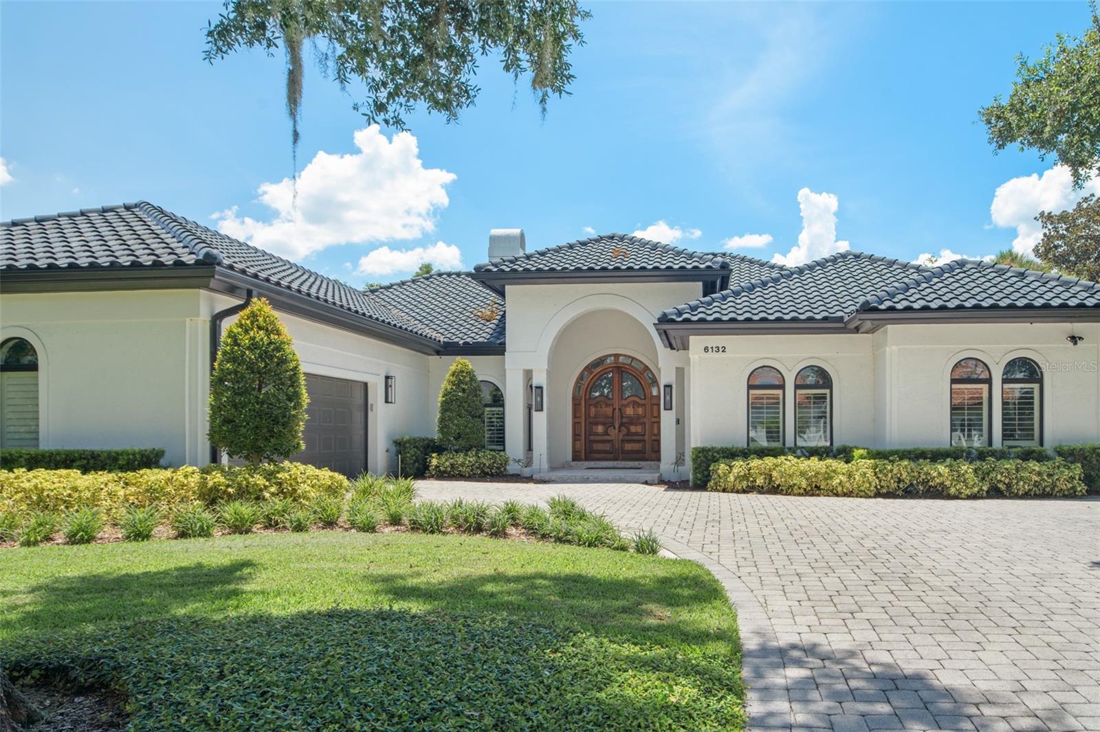 Located within the gates of the Isleworth Golf and Country Club community, this renovated luxury golf villa presents an opportunity to live in one of Windermere’s most desirable neighborhoods. The updated home spans over 2,800 square feet with 3 bedrooms and 3 and a half bathrooms. Displaying intricate detail throughout, including textured finishes and relaxed rustic brick arch ways, you will flow through the open entry and into the family room with sunlit high ceilings. The primary suite features a newly updated modern bathroom, and the serene tropical backyard features an expanded lanai with retractable screens overlooking the glistening pool. Enjoy the convenience of being just steps away from The Club House, driving range and tennis center.