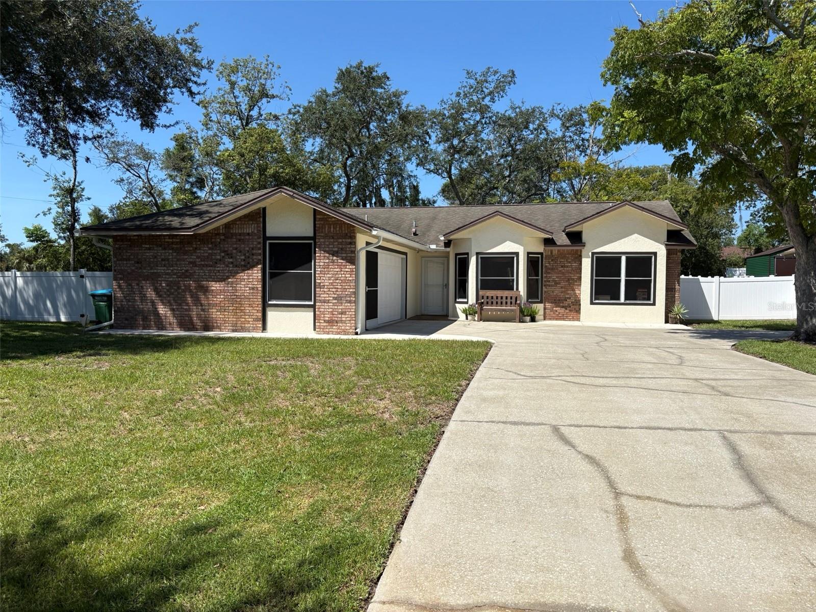 “From the moment we walked in, we knew this was home—a place to start our family and make lifelong memories.”
This beautifully maintained 3-bedroom, 2-bathroom Deltona home sits on an oversized corner lot directly across from the peaceful Lake Theresa. Built and cared for with love every detail reflects quality, style, and comfort.
Inside, wide-plank wood-look porcelain tile flows seamlessly through the home. High ceilings and an open layout fill each space with natural light, creating an inviting atmosphere for family, friends, and entertaining. Bay windows, French doors, and a neutral color palette add charm and versatility, ready for your personal touch.
The custom kitchen is the heart of the home, featuring white shaker-style cabinets, gorgeous natural stone countertops, a subway tile backsplash, stainless steel appliances, a deep farmhouse sink, and a breakfast bar ideal for casual meals or socializing. The living room, accented with a tile wall, opens directly to the backyard, blending indoor and outdoor living effortlessly.
The ensuite bath has been thoughtfully updated with double sinks and modern vanities, while the hall bath is equally functional and stylish. An interior laundry room adjacent to the 2-car garage ensures everyday convenience.
Outside, the once-forested backyard has been transformed into a private retreat. A central wooden deck, stamped concrete patio, and full vinyl fencing create ideal spaces for gatherings, celebrations, or quiet evenings. The 10x24 screened porch—with removable vinyl windows—extends living space year-round.
Recent updates include a 2019 hot water heater, 2019 HVAC, 2018 septic and drain field, fresh interior and exterior paint, ceiling fans, Hembar pull-down shades, and garage screen doors.
Located just minutes from I-4, the Orlando Metro area, and nearby beaches, this home combines style, functionality, and a serene, private setting. Move in and start making memories in a space that’s been loved from the first step to the last. Note: Room measurements are not exact, may be rounded up and should be confirmed by all visitors.