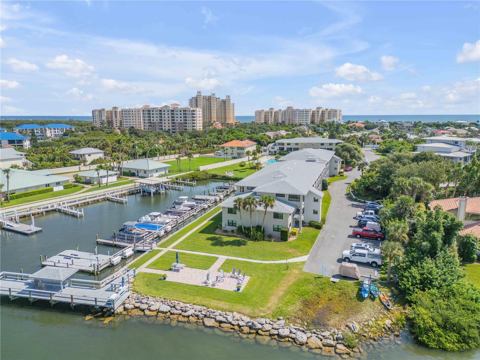 Welcome to Ocean Inlet Yacht Club, one of New Smyrna’s best-kept waterfront treasures, where boating, sunsets, and the beach come together in perfect harmony. This beautifully remodeled, furnished 2 bedroom, 2 bath condo has been completely opened up and thoughtfully designed with high-end finishes throughout. What makes this property truly stand out? A boat slip, a rare find that gives you instant access to the Intracoastal Waterway, world-class fishing, and some of NSB’s best waterfront dining. Hop on your boat, and you are on the water in minutes. Boat slip #19, 8' beam, 21' length. Inside, the open-concept floor plan features a chef’s kitchen with modern coastal style, spacious living and dining areas, and bright natural light. Both bedrooms offer generous closets and serene comfort, while the fully updated bathrooms bring a touch of spa-like luxury. This second-to-the-end ground floor unit means extra privacy, and the community itself is impeccably maintained. Imagine sipping morning coffee or evening cocktails while watching unforgettable sunsets from the waterside patio or pool. Just a short walk brings you to Smyrna Dunes Park complete with boardwalks and nature trails. Don’t miss your chance to rent this lovely slice of paradise. This condo is also available to purchase.