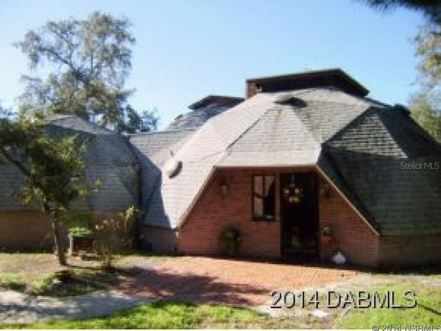 "AMAZING" One of a kind 4 bedroom, 2 bath Geodesic Domed Home. In the heart of Port Orange on a "Nature" cul de sac lot that is 1.25 acres. Features an attached over sized 2 car garage, PLUS a 6 car detached garage and workshop. Huge master suite with jacuzzi tub and balcony overlooking your lush wooded lot. 3 guest bedrooms plus a private bonus room for an office, den or family room. Great area features a super high domed ceiling, fireplace and sliding doors to a large screened patio. You must see this home to truly appreciate. All information recorded in the MLS is intended to be accurate but cannot be guaranteed. ;Water: City