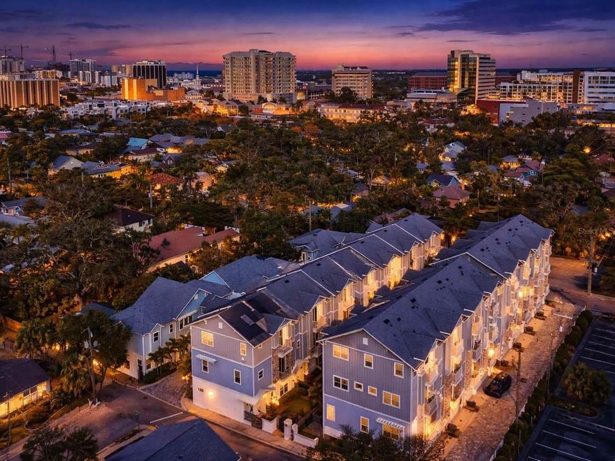 One or more photo(s) has been virtually staged. Experience the ultimate urban oasis in this impressive downtown townhouse, where luxury meets convenience in a vibrant neighborhood just steps away from the best that Sarasota has to offer! This exceptional property features a private elevator connecting every level, ensuring effortless access throughout the spacious interior. This multi-level townhome maintains a minimal urban footprint without sacrificing comfort. This single-family residence boasts nearly 2,500 square feet. It features 3 bedrooms, 3.5 baths, a home office, and ample storage on every floor, all designed with functionality in mind. A gated entrance defines your green space, featuring paver bricks, lovely landscaping, and a covered front porch. The foyer features a climate-controlled flex room for storing all your things, along with ground-level access to the attached two-car garage. As you proceed to the main level, you’ll discover an open floor plan with a convenient half bath and combined living and dining areas, next to a beautiful kitchen. It boasts quartz countertops that complement the white raised-panel cabinetry, which is accented by a herringbone-patterned backsplash illuminated with task lighting. A center island features an induction cooktop, a retractable hood vent that effectively removes smoke and odors, and breakfast bar seating. Additionally, a stainless-steel apron sink is paired with modern, high-quality appliances. Two distinct balconies offer park views to the east and city vistas to the west, each accessed through sliding glass doors. The owner's floor includes an en-suite bath, a generously sized walk-in closet, and an additional balcony. The luxurious bathroom boasts quartz countertops, furniture-quality cabinetry, double sinks, tile, and a spa-like shower with a glass-front enclosure, an overhead rainfall showerhead, and a secondary nozzle. Nearby, you’ll find a home office with its own balcony, as well as a dry bar complete with a beverage refrigerator. Additionally, this floor offers a well-appointed laundry room. Warm hardwood flooring spans three levels, leading to inviting neutral carpeting on the top floor. Explore two stunning bedroom en-suites, each boasting balconies, spacious walk-in closets, and elegant herringbone tiled baths. One features a sleek shower, while the other invites relaxation with a lovely tub-shower combo! For added peace of mind, the property features hurricane-rated windows and doors. With its advanced smart home features, this townhouse not only offers comfort and luxury but also convenience at your fingertips. The Enclave is in Laurel Park, a historic neighborhood in Sarasota. It offers a vibrant metropolitan lifestyle just west of the trail, situated across the street from Payne Park. This county-maintained venue features tennis courts, a skate park, a café, an amphitheater, cycling paths, disc golf, picnic tables, a playground, and a water feature. City sidewalks along Laurel Street stroll to the epicenter of Downtown Sarasota. You can visit the famous Farmers Market to explore fresh local produce on the weekend, and head to the Bayfront to launch your kayak for a day on the water. This area offers plenty of options for entertainment, dining, and shopping. Additionally, it provides access to Legacy Trail, which features miles of biking opportunities. Sarasota Memorial Hospital and Morton’s Market Plaza are only a few blocks away. Plus, you’ll find the world-renowned sugar-sand beaches of Siesta Key nearby!