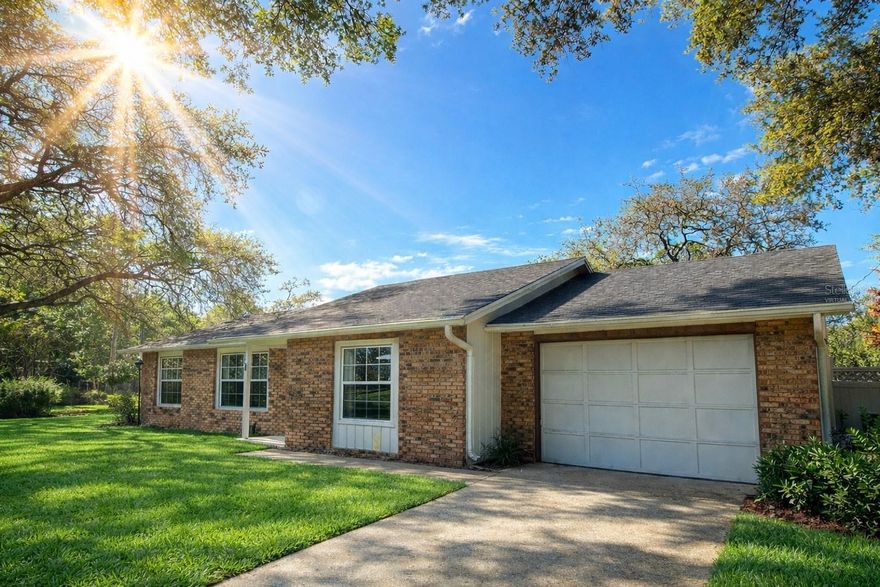One or more photo(s) has been virtually staged. Expect to be impressed with this beautifully updated 3-bedroom, 2-bath home situated on a large corner lot in the well-established Country Club Estates community. From the moment you arrive, the shaded yard, mature trees, and inviting courtyard setting create a private, park-like feel. Step inside to a light and functional layout featuring updated LVP flooring throughout the living areas and bedrooms, with tile in the kitchen and dining spaces for easy maintenance. The kitchen has been thoughtfully updated with quartz countertops, shaker-style cabinetry, stainless appliances, and a pass-through window to the expansive screened porch, perfect for entertaining. The living and dining areas flow seamlessly, creating a comfortable space for everyday living or hosting guests. The primary suite offers a well-appointed bath with updated vanity, stone countertop, and a step-down shower, while the guest bathroom has also been updated with a tiled tub, granite countertop, and modern finishes. Out back, the oversized screened porch (23x13.5) serves as a true extension of the home, complete with ceiling fan, lighting, and a serving window from the kitchen, ideal for gatherings. The fenced backyard is shaded and private, with room to relax or play. Additional highlights include updated lighting, fixtures, switches, and outlets throughout, a newer water heater, and a one-car garage with window, side entry door, and generous dimensions (13’9” x 25’1”). Conveniently located near shopping, dining, and major roadways, this home offers both comfort and accessibility. A well-rounded property that shows pride of ownership throughout and is ready for its next owner to enjoy.