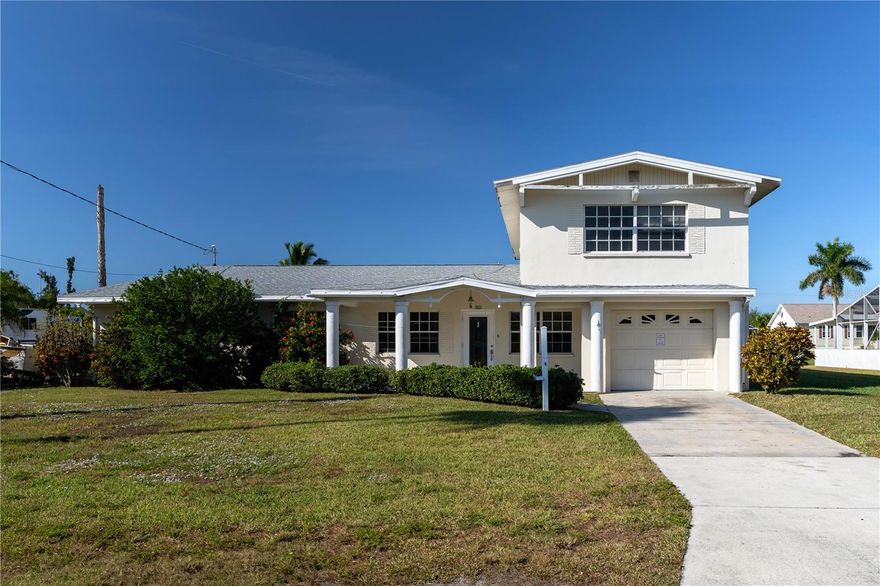 RARE WATERFRONT VALUE IN PUNTA GORDA — 85FT SEAWALL, DOCK & SUNSET VIEWS - This 4 bed/3.5 bath home offers the perfect blend of opportunity and lifestyle: boating access to Charlotte Harbor paired with the chance to transform a larger canal-front property into a personalized waterfront retreat. With 85 ft of seawall and a private dock just steps from the back door, it’s easy to picture mornings on the water, afternoons in the sun, and evenings spent enjoying the colorful sunsets over the canal. THIS IS YOUR OPPORTUNITY TO OWN ON THE WATER!! Inside, the home offers an impressive amount of living space beginning with a front living room featuring classic terrazzo flooring and large windows that brighten the room throughout the day. A separate family room is the perfect place to relax with friends and family. The combined kitchen and dining area span a wide footprint, giving you a strong foundation for a full renovation. There is abundant counter and cabinet space, an easy flow between rooms, and clear potential to reconfigure the layout into an open-concept design that connects the living room and family room. For buyers looking to modernize, the scale of this room allows for an island, expanded storage, or a more contemporary design. The first floor also features two bedrooms, each offering convenience and flexibility. One bedroom has a private en-suite bath and direct access to the lanai, creating a natural guest suite. Upstairs, the spacious, master suite features a fireplace, balcony access, and a canal view. A full en-suite bath and a large walk-in closet complete the space. The fourth bedroom, also upstairs, includes an attached half bath and its own walk-in closet, making it suitable for a second office, guest room, or flex space. The attached garage connects to a large laundry room with a storage closet and an exterior door leading directly to the backyard. It’s a natural mudroom setup — perfect for rinsing off after a day on the boat before heading inside. Outdoor living is anchored by an expansive covered lanai and open-air patio. This space is ready for outdoor dining, seating areas, or future enhancements. The backyard leads directly to dock, making it easy to hop aboard and be out on the water within minutes. With no HOA restrictions, you have the freedom to add a pool, upgrade outdoor spaces, or modernize the waterfront to match your vision. For buyers looking for a larger home on the water & the opportunity to design a waterfront home to their style and standards, this property offers size, layout, exposure, and access that are difficult to match. An opportunity like this doesn’t come along often. Make an appointment today.