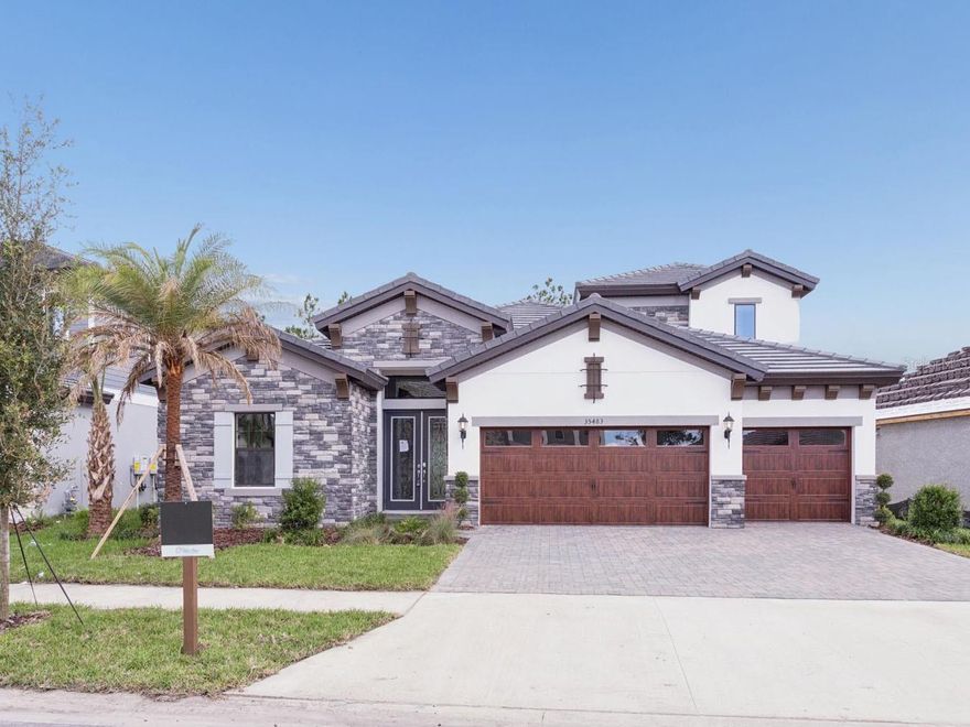 One or more photo(s) has been virtually staged. Biscayne II - 
Imagine settling into your brand new home right away—the Biscayne II is waiting for you. This two story beauty offers a layout that just makes sense, giving you wide open spaces for gathering while keeping the bedrooms private and quiet. The heart of the home is absolutely stunning: a seamlessly combined grand room, incredible kitchen, and casual dining area, all flowing perfectly out to a large covered lanai for easy outdoor living. You'll love the airy, expansive feeling created by the impressive 12 foot ceilings that soar over the foyer, grand room, and kitchen. When it's time to relax, the owner's retreat is a true sanctuary, boasting huge walk in closets and a luxurious master bath complete with a soothing garden tub and walk in shower. Upstairs, you'll find even more flexibility with a versatile bonus room, a fifth bedroom, and an additional bathroom. Plus, this home is loaded with incredible style, featuring premium selections like Maddox Premium Finish cabinets, sleek New Calacatta MSI Quartz countertops, and warm Nutmeg Luxury Vinyl Plank flooring. And because it comes with built in upgrades like an optional den, an enhanced owner's closet, and an extended lanai, you're getting a home that's truly maximized for comfort and a welcoming atmosphere. This is more than a house; it's the perfect place to start your next chapter. Listing Price amount for this Pending Sale includes Design and Structural Options.