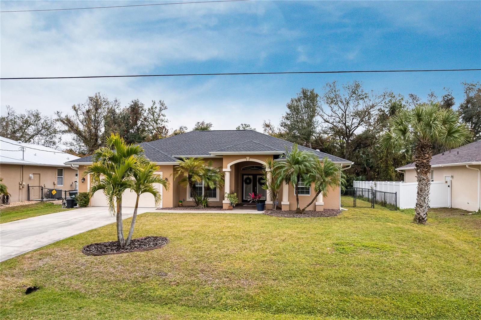 This is your opportunity to make this beautifully maintained 3 bedroom, 2 bath home yours! Located in a quiet North Port neighborhood this home has plenty of room for family and friends with over 1800 square feet of living space, great room, dining room, family room, and spacious kitchen. You will enter into a bright and open floor plan with sliders in the main living area leading to the lanai which brings the outdoors into your living space. Tastefully appointed with tile in the main living areas, soaring volume ceilings, fresh interior paint with color accent walls, plant shelves to display your treasure and collectibles, arched doorways, and new decorator light and fan fixtures. The family room has beautiful built in shelving and decorative wood cabinetry. The kitchen is a culinary enthusiast’s dream boasting stainless appliances including 3-door fridge, smooth counters with tile back splash, ample counter space, and long breakfast bar that opens to the main living areas for easy entertaining. The owner’s suite will be your private retreat with 2 walk-in closets and en suite bath with spacious walk-in shower and his and hers sinks. You will spend most of your leisure time relaxing on your tiled lanai overlooking your private fenced backyard. Great place for entertaining! Ample storage with 2 walk-in closets in master bedroom and one in the 3rd bedroom. Other key features include dedicated laundry room, new roof in 2022, storm shutters and hurricane code garage door for peace of mind during inclement weather, new AC system in 2022, irrigation system, and water softener. Impressive curb appeal with pillared front entrance with double-door entry, decorative rock and landscape curbing, and flowering shrubs. Seller has an assumable VA loan for qualified VA buyer. The best part is the location. You can enjoy local waterways and beaches, dining, shopping, and golf courses that make this area so special. You can also explore the waterfront public parks with bike and walking trails, pickle ball parks, picnic areas, and boat ramps that give you access to the Peace and Myakka Rivers, beautiful Charlotte Harbor, and the blue waters of the Gulf of Mexico. And don't forget about historic downtown Punta Gorda, Venice, and popular Fishermen’s Village with quaint shops and cafes. Easy access to Interstate 75 with Venice, Sarasota, and Tampa to the North and Fort Myers and Naples to the South. Great home in a great neighborhood. **PLEASE ENJOY THE 3D INTERACTIVE VIRTUAL TOUR ASSOCIATED WITH THIS LISTING