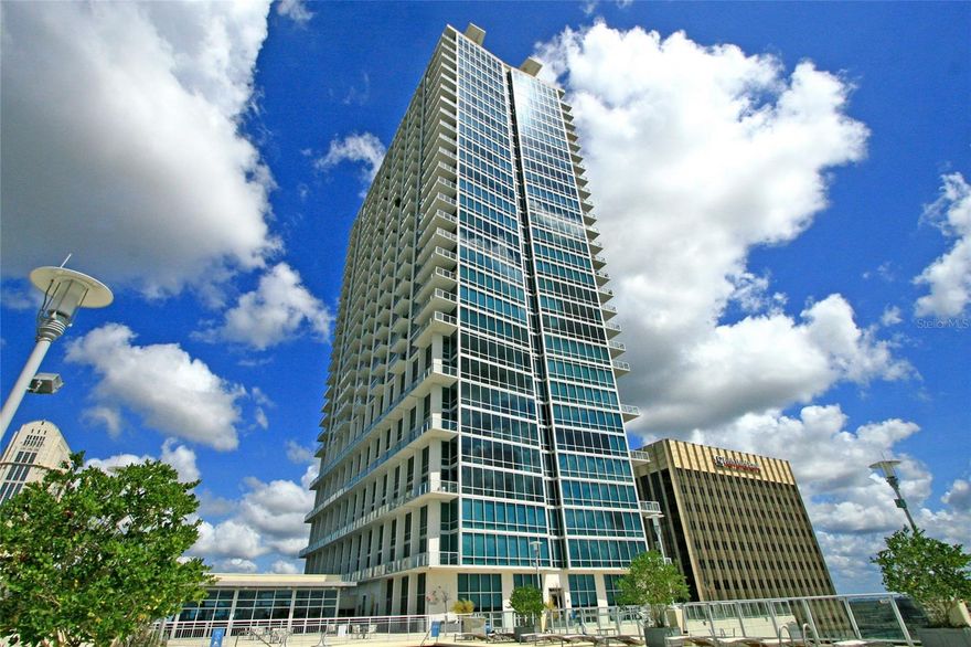 Distinctive GLASS CORNER LOFT 1-bedroom sky home located on levels 10 and 11 with city and sky views featuring a gourmet kitchen, granite countertops, wood floors, interior laundry, a walk-in closet, a huge exterior wraparound balcony, 20 ft. ceilings, and gorgeous views of downtown Orlando, both day and night. This is the perfect home in the perfect location to enjoy the downtown way of life! Adjacent to Lake Eola in the heart of downtown Orlando, THE VUE offers residents the finest address to have in the City Beautiful. Lavish lobby, staffed with a 24-hour doorman, and a resident-only parking garage with biometric fingerprint access, will ensure a safe and private environment. City and lake view Jr. Olympic-size pool, 30,000 sq. ft. amenity deck, multi-million-dollar health club, tennis courts, media room, dog walk, and Club Vue Lounge are exclusively for residents and their guests. Acoustically engineered concrete floors and walls, as well as acoustically sealed entry doors, minimize sound transfer between homes and are second to none. Run around Lake Eola, walk to work, step out your door to diverse dining, shopping, and entertainment. Living at THE VUE means urban living becomes stress-free living.
