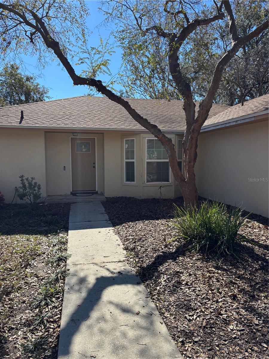 This solid concrete block home, built in 1987, features three bedrooms, two bathrooms, and a two-car attached garage. A new roof was installed in 2021. A new septic tank was put in in 2022. The windows and doors have been updated. It has a family friendly split plan layout with separate dining and living room. The kitchen has beautiful solid countertops with a bar for that nice open feeling. Carpet where you would like it. Tile in those places that can get wet like bathrooms, laundry room and kitchen. Excellent storage with a walk in closet in the primary bedroom and many closets throughout the house. The enclosed back porch looks out over a spacious back yard with mature landscaping. House has good bones. Interior could be lived in as it is or updated for a more modern look. Regardless, this is a great home conveniently located near 98 for easy access to the Polk Parkway or 60. This would be an excellent starter home or a great choice for downsizing. All at an affordable price. Don’t delay—this may be the home you’ve been searching for!