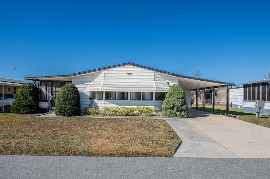 Come see this lovely 2 BEDROOM 2 BATH DOUBLEWIDE located in the 55+ community of FOXWOOD LAKE ESTATES, where you own the land! This FULLY FURNISHED home includes a large LIVING ROOM, formal DINING ROOM, EATING NOOK in the kitchen and a SPACIOUS FLORIDA ROOM. The PRIMARY SUITE spans the entire width of the home and has THREE WALK-IN CLOSETS, and an ENSUITE BATH. The LAUNDRY and WORKSHOP are located in the UTILITY SHED. The kitchen was updated in 2014, Florida Room windows were replaced in 2015, roof was replaced in 2016, concrete parking pad and sidewalk added in 2019, laminate floors in kitchen and dining installed 2025. Amenities include a clubhouse with a library, game room, fitness center and more. There is also a heated community pool, sauna, shuffleboard, pickleball, a paved walking path around the community lake, and a dock for fishing. This is more than a home - it's a lifestyle! This is your chance to live in a community where people love sharing their hobbies and interests. Enjoy pancake breakfasts, pot-luck dinners, dances, pool aerobics, bingo and more. **Note: Electronic lift chair in LR, twin bedspreads in guest room, and artificial plants (used for staging) do not convey.**