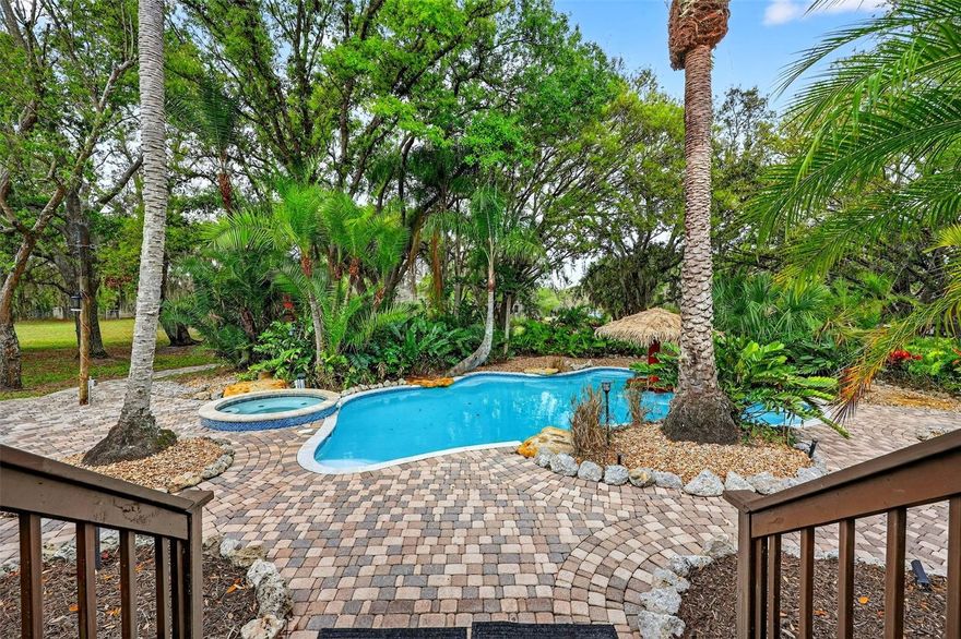 Looking for a Sarasota property where you can have horses, a guest cottage, a pool oasis, and 6 acres of privacy just 30 minutes from Siesta Key Beach?

This private Sarasota acreage estate offers the perfect blend of country living, outdoor entertaining, and equestrian potential while still remaining convenient to Sarasota’s amenities and top-rated schools.

Situated on 6 fully fenced acres, this unique property features a 4 bedroom, 2 bathroom custom home built in 1994 and a 1 Bedroom, 1 Bathroom guest cottage, surrounded by majestic oak trees, lush landscaping, and wide-open space to enjoy Florida’s natural beauty. Designed with solid wood construction and rustic country character, the home offers warmth, charm, and architectural details rarely found in newer homes, including high ceilings and a beautiful stained glass accent that add personality and craftsmanship throughout the interior.

Inside, the layout offers flexibility with two bedrooms and two bathrooms downstairs, including the primary suite, and two additional bedrooms located upstairs. The primary bathroom has been recently updated with a mountain-lodge inspired shower featuring rock textures and marble-look walls, adding to the home's rustic character. Recent updates provide peace of mind for future owners, including all water plumbing lines replaced in 2023, a new hot water heater, new garbage disposal, new kitchen appliances, new ceiling fans, newly resurfaced pool (2026) and a recently serviced septic system.
The outdoor living space is truly the highlight of this property. Step onto the back porch overlooking a tropical backyard oasis featuring a lagoon like pool and spa creating the perfect setting for relaxing or entertaining. The pool area is surrounded by extensive landscaping, large decorative rock accents, and even a poolside stage, making this home ideal for gatherings, celebrations, and outdoor entertaining. 

The property also features a private exterior guest cottage / mother-in-law suite with 1 bedroom, 1 bathroom, and a kitchenette, designed with a cozy country theme. This flexible space could serve as an Airbnb rental, guest house, private office, multigenerational living space, or retreat for visiting family and friends.

For those seeking room for hobbies, vehicles, or animals, the property includes a large six-bay shed / barn structure that can be used for horse stalls, farm equipment, workshop space, car storage, or recreational vehicles. The land also features a pond and a separately fenced pasture, offering excellent potential for horses, hobby farming, or simply enjoying the peaceful country setting.
Unlike many properties in the area, this home is located within the Voluntary Section of the HOA, allowing owners the freedom to bring boats, trailers, campers, work trucks, RVs, and recreational equipment onto the property.

Residents of Myakka Valley Ranches enjoy private paved roads, two community nature parks, miles of riding and walking trails, and close proximity to Myakka River State Park, creating a unique outdoor lifestyle while remaining conveniently located approximately 30 minutes from Siesta Key Beach and about 45 minutes from downtown Sarasota.

Properties like this are rare to find — a Myakka Valley Ranches horse property in Sarasota with acreage, guest cottage, pool, and barn, offering privacy and space while still being close to city amenities. Schedule your private showing today!