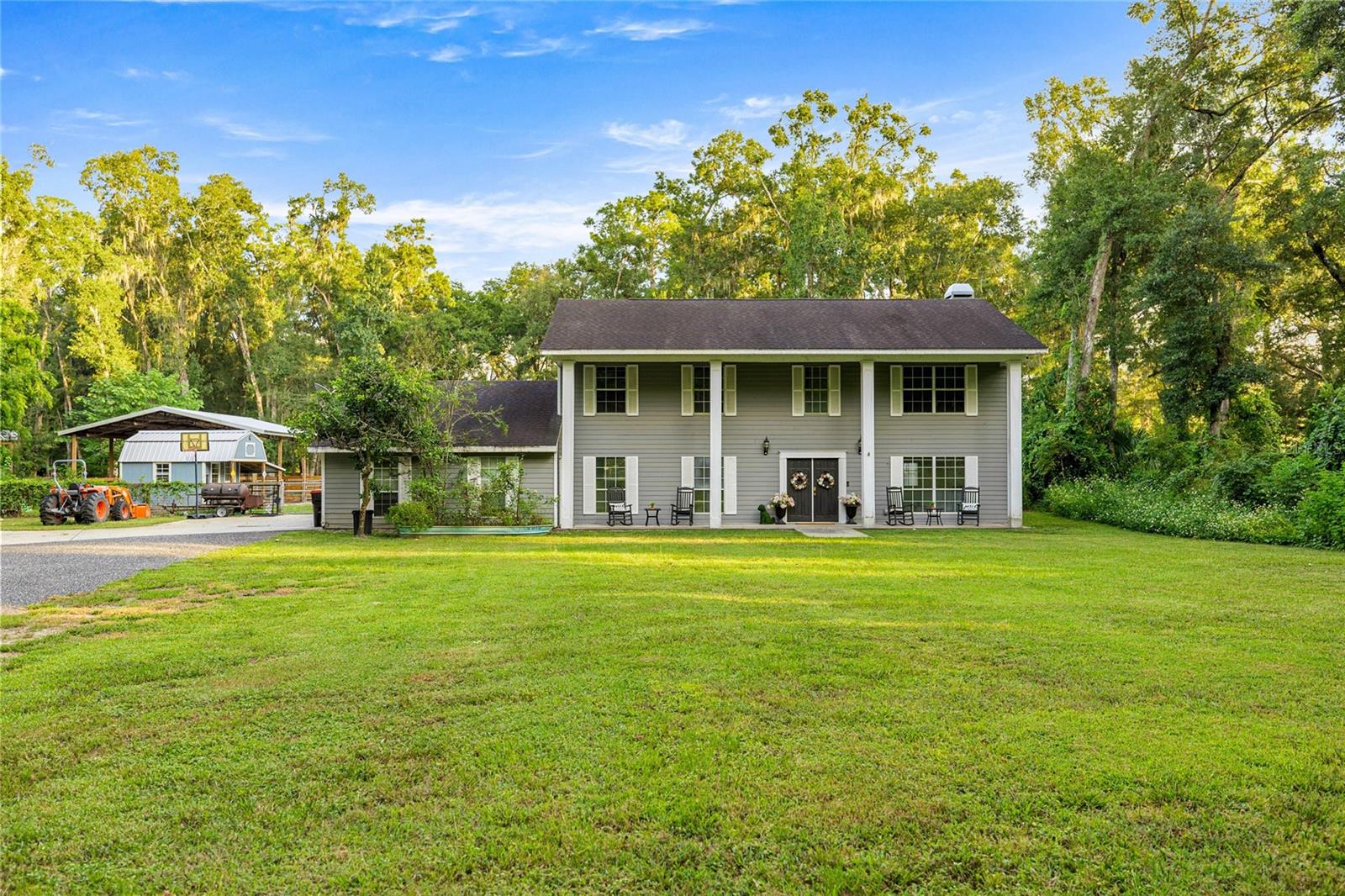 AWESOME home for sale! This stunning four bedroom, three bathroom two-story home offers the quiet serenity of country living on a beautifully fenced 3-acre lot surrounded by majestic granddaddy oaks and abundant wildlife. Nestled in the highly sought-after Southeast Ocala farmland, you'll enjoy the perfect blend of seclusion and convenience. Located just minutes from all the essentials in Ocala and surrounding areas. Located in one of Ocala’s best-kept secrets, Redding Circle, a quaint and private neighborhood of only 12 homes. Each with 3-acre parcels and a privately maintained road. Tucked behind the beautiful Turning Hawk community, this home offers unmatched tranquility while still being close to everything. Step inside to discover a spacious, well-designed floor plan with generously sized rooms throughout. The heart of the home is the gorgeous remodeled kitchen in 2020, featuring granite countertops, a large center island,
stainless steel appliances, a farmhouse sink, space-saving microwave drawer, soft-close cabinetry, and abundant pantry space with convenient pull out drawers, all complemented by elegant wood-look ceramic tile that flows throughout the first floor. The inviting family room boasts a charming wood-burning fireplace and stylish barn doors that can separate the space from the front living area, offering flexibility and comfort for family living or entertaining. Back of property is fenced and offers a pole barn, a chicken coop with run and a kids play house that is actually a utility shed.