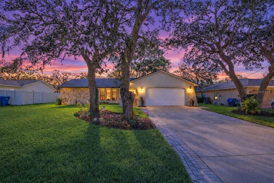 Welcome home to this light-filled 2-bedroom, 2-bath, 2-car garage split-plan residence, perfectly situated on a .23-acre lot backing to a peaceful wooded area, offering privacy and serenity. From the moment you arrive, you’ll appreciate the beautiful landscaping and fully fenced yard, creating an inviting outdoor retreat.

This home truly stands out with all major systems already upgraded, delivering exceptional peace of mind. Highlights include a new roof (2020), new septic drain field (2022), and Rheem water heater (2023). In 2025, the home received an impressive list of improvements: a New Rheem HVAC system, New rain gutters, New front door, New storage shed, New sod in the front and side yards, a New irrigation system fed by a private well, and a New stainless steel stove.

The kitchen is equipped with stainless steel appliances throughout, including a refrigerator and dishwasher replaced in 2020, offering both style and functionality. The thoughtful design extends outdoors with pocket sliders to the rear patio with glass sliding windows, which is fully covered under the main roofline—no flat roof—providing durability and seamless architectural continuity. This room can be extra space for exercising, your retreat or just for what it is, a lovely porch! 

Lovingly maintained and thoughtfully updated, this home has clearly been well cared for and enjoyed. With all the big-ticket items already completed, you can move right in and enjoy the comfort, privacy, and confidence that comes with owning a truly well-maintained property.