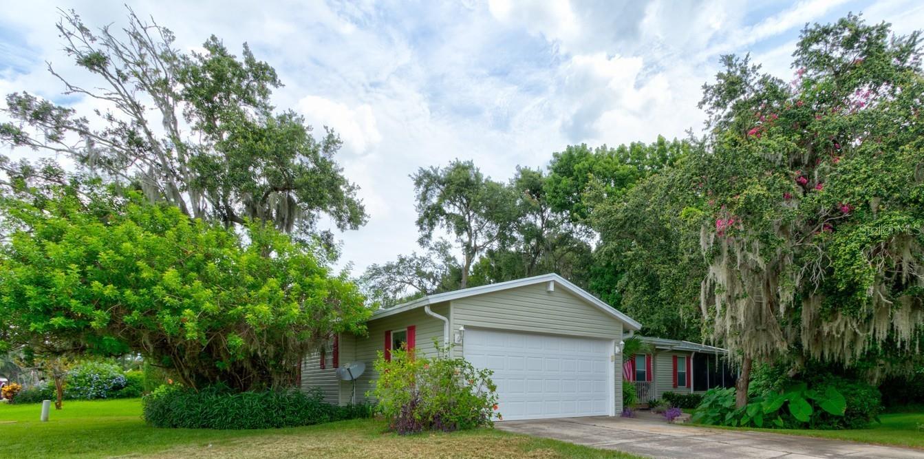 Welcome to Lighthouse Cove, a gated golf-cart friendly community nestled in the charming town of Oak Hill, Florida. This beautifully maintained 3- bedroom 2-bath home sits on a lush corner lot surrounded by mature trees and native greenery. Relax and enjoy morning coffee or cool evenings on the furnished side porch with a spacious 14x8 storage room, an added bonus for your holiday decor, hobbies or beach toys. Inside, the open floor plan is filled with natural light from large windows and a skylight. The kitchen features newer luxury vinyl plank flooring, updated appliances, a stylish new faucet, and a central island offering extra counter space and storage, perfect for meal prep and entertaining. The cozy, inviting family room could make a perfect sports watching area, as well as listening for frogs singing after a rain, or owls hooting from the dedicated green space. The sunny living room with its vaulted ceilings and huge triple windows is your go-to space for relaxing with a good book and a refreshing drink. The primary suite easily accommodates a king sized bed and includes a spa-like
bathroom with ocean decor, with garden tub, a walk-in shower and a double sink vanity. Guest bedrooms are located on the opposite side of the home for added privacy, and the third bedroom makes a great home office or flex space. The owners are including most of the furnishings such as bedroom suites, sofas, an electric reclining loveseat, tables, lamps and wall hangings. Dining table and 6 chairs makes it practically turn key. Lighthouse Cove is perfect for a winter retreat or a year round home with a community pool, pickleball and shuffleboard courts, and a newly renovated clubhouse where various committees meet and friendly groups play cards, bingo and shoot pool. You are just minutes from the natural beauty of Seminole Rest Park, and Canaveral National Seashore, the excitement of Kennedy Space Center and the world-class fishing/shrimping of Mosquito Lagoon. Don't miss this opportunity to live where nature meets comfort and convenience!