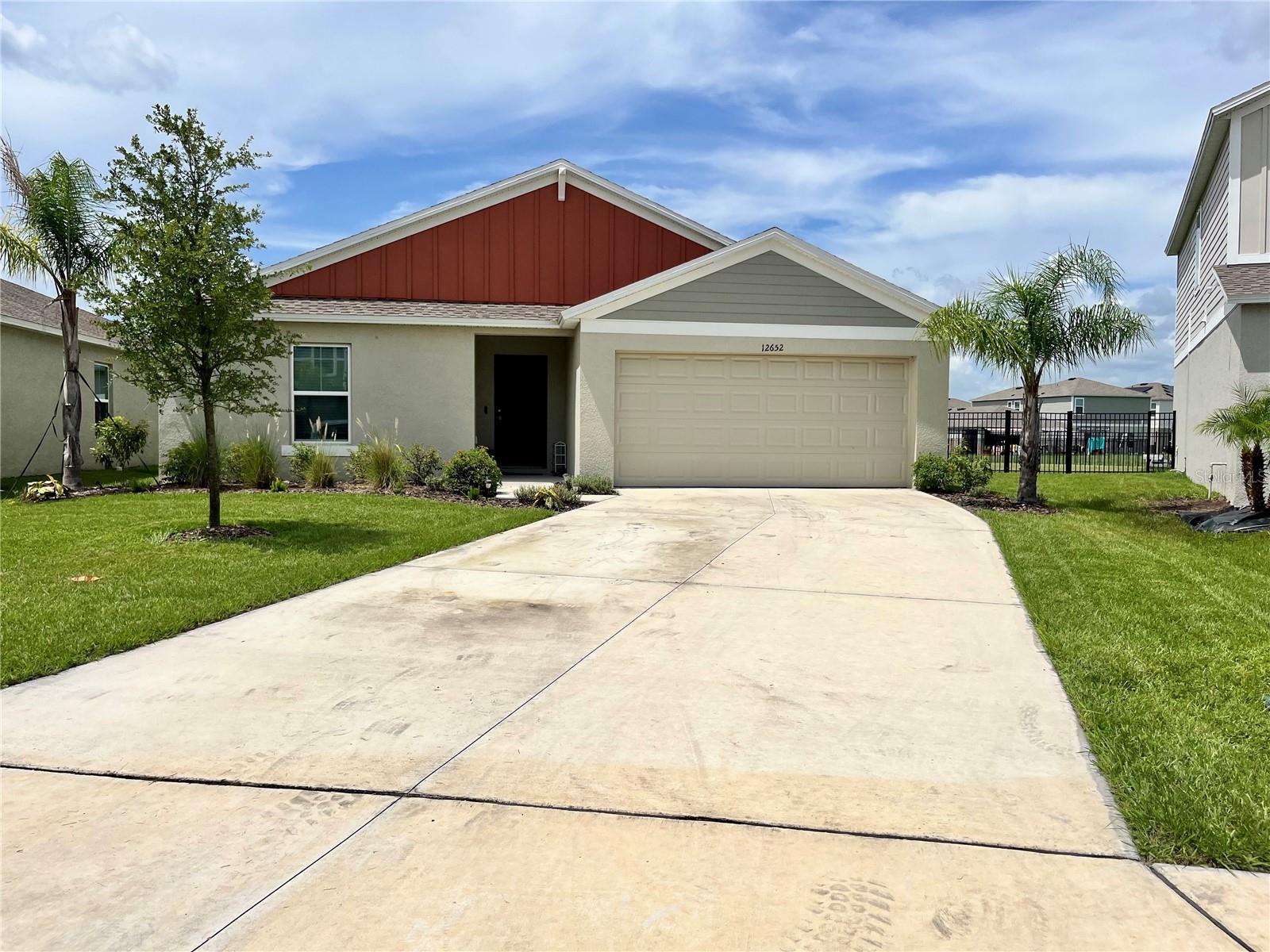 This single-story home, built in 2023, is located in Parrish’s Crosswind Point community, providing a more ‘out in the country’ feeling, but with schools, shopping, restaurants, and medical facilities close by. With access to I-75 via Hwy. 301, all the recreational activities, including professional sporting events and some of the best beaches in the world, are available in Bradenton, Sarasota, St. Petersburg, and Tampa. Plus – 3 international airports within approximately an hour’s drive from your front door! This house offers an open concept, high ceilings, 3 bedrooms, 2 bathrooms, inside laundry room and a 2-car garage. The house is located on a more private looped street, on a lot with a fenced-in backyard that backs up to wetland views, adding distance between the homes on the other side. With luxury vinyl plank flooring, the living area not only opens onto the covered back lanai with views of the yard and wetlands, but also is open to the kitchen, breakfast bar, and dining area. The kitchen is light and bright with light grey cabinets, whitish quartz countertops, GE stainless-steel appliances, and a large pantry. The primary bedroom is located in the back of the house, separate from the secondary bedrooms and bathroom on the front of the house. The owners’ bathroom has double vanities, shower, and a walk-in closet. Living in Crosswind Point community has much to offer residents who are ready to live bit further away from the downtown and busy areas but want the peace of knowing that the services they need are not that far away.