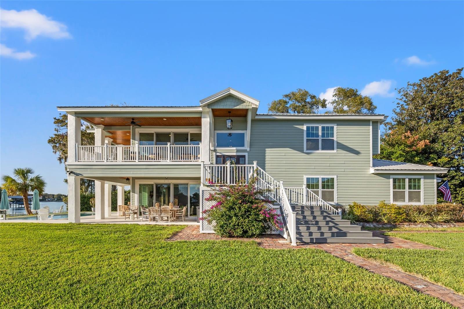 Escape to your own lakeside paradise at 2406 Carroll Place! This 4 Bedroom, 3.5 Bath, 2 Car Garage, Pool home is a haven for those who appreciate the finer things in life.
Situated on the exclusive Lake Carroll, this unique property offers unparalleled water views from every angle. As the only house with 3 sides of water views, you'll experience the tranquility of lakeside living like never before. The house, nestled on just less than an acre, takes pride in its prime location on a peninsula, making it a one-of-a-kind house on a one-of-a-kind lot.
Upon arrival, you'll be greeted by the elegance of a gated property with an automatic Iron Gate, ensuring your privacy and security. As you make your way down the custom elongated driveway, a picturesque live oak tree and mature fruit trees grace your path, adding a touch of natural beauty to your arrival. The charm continues with pine ceilings on double covered wrap-around porches, perfect for savoring the picturesque surroundings.
Inside, luxury plank vinyl flooring bathes the entire home in sophistication, complemented by vaulted ceilings, panoramic windows and 8 foot sliders in the living room that enhance the sense of space and light that lead to the wrap around porch.
The kitchen is a chef's dream, featuring a Wolf gas range, pot filler, KitchenAid appliances, double oven, wine fridge, custom lighting, and a hidden custom pantry. A unique floor plan places the kitchen on the second floor, providing breathtaking views of Lake Carroll to accompany your culinary endeavors.
The primary bath is a sanctuary of relaxation with a soaker tub, standalone shower, makeup vanity, and Carrera marble accents. The spacious primary bedroom boasts two custom walk-in closets, ensuring ample storage.
Downstairs, a second living room, with a cozy gas fireplace and a convenient mini bar with sink and refrigerator for entertaining. Gorgeous sliders open up to a brand new saltwater pool with a 6ft sun shelf, bubblers for all your lake and pool parties. Stepping back inside, three bedrooms and two full baths downstairs provide space for family or guests, while the indoor downstairs laundry room adds practicality to daily life.
The oversized garage is outfitted for an electric car, a bonus room with AC, perfect for tools or a workshop, and side storage attached to the home ensures that this lakeside oasis has a place for everything.
Boating enthusiasts will be delighted by the Trex Dock and 10,000 lb boat lift, ready to launch you onto the ski lake for endless aquatic adventures.
Immerse yourself in the serenity of lake living , where every sunset is an exquisite masterpiece. Don't miss the chance to make every day a lakeside retreat – schedule your grand tour today!
Metal Roof (2019), 2 ACs (2019), Navien Gas Tankless Water Heater (2020), Impact Windows and PGT impact sliders, Salt water pool (2023),
RING Cameras and Doorbell, Propane Tank (2019), Halo entire house water filtration system (2022), Fully landscaped and full yard irrigation pump (2022) comes from the lake. Bedroom Closet Type: Walk-in Closet (Primary Bedroom).