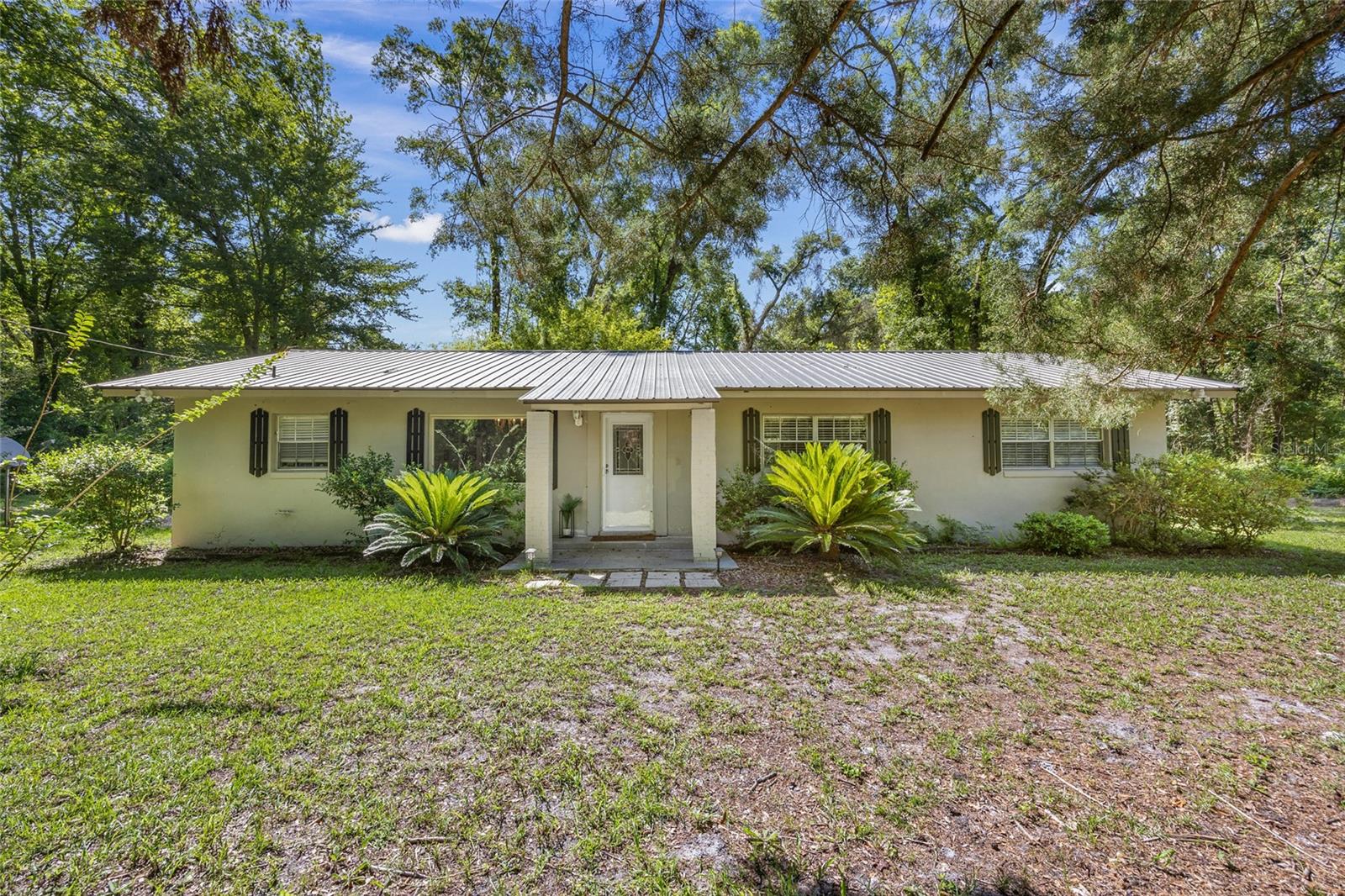 Just 1.5 miles from the North Entrance of Ichetucknee Springs State Park, this fully remodeled 3-bedroom, 2-bathroom home on 1.5 acres is perfectly positioned to enjoy all that North Florida has to offer. Located on a paved road with no HOA, this property gives you the freedom to live how you want—whether it’s a full-time residence, a weekend getaway, or a short-term rental opportunity. Built from durable concrete block, the home is move-in ready with a stylish, modern interior. Updates include new laminate flooring throughout, fresh paint, a completely renovated kitchen with new stainless steel appliances, and two fully updated bathrooms. Out back, unwind on the private deck or store your gear in the backyard shed. Just minutes from multiple springs and rivers, including the Santa Fe and Suwannee Rivers, this location is ideal for swimming, kayaking, and tubing. You’re also conveniently located—only about 30 minutes to Lake City and 45 minutes to Gainesville, giving you easy access to shopping, dining, and medical facilities while still enjoying the quiet charm of Fort White. No HOA, unbeatable location, and a fully updated home—this one has it all.