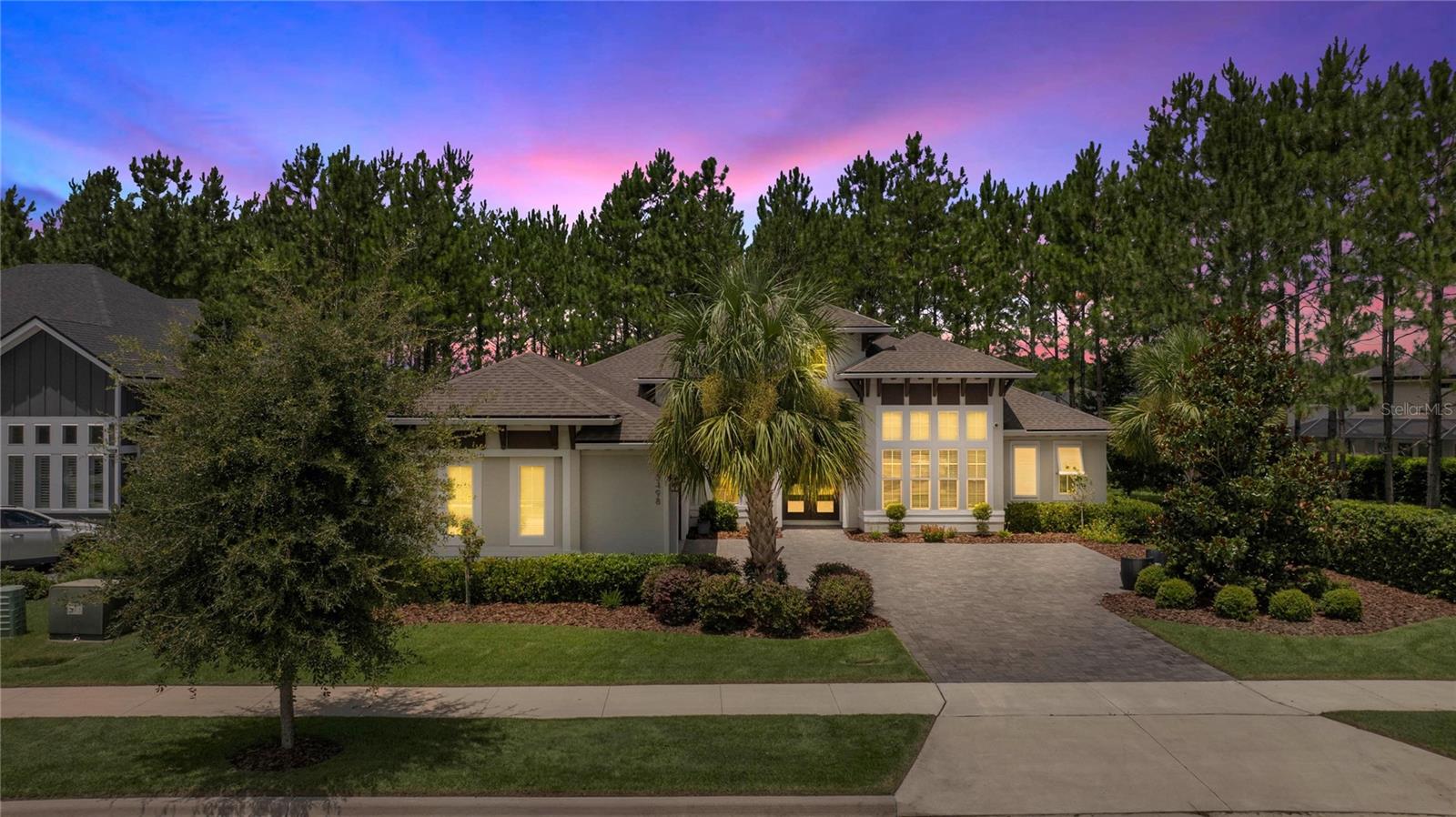 Discover the perfect blend of comfort, style, and convenience in this beautifully maintained home nestled in one of the most desirable neighborhoods. This residence offers an inviting floor plan designed for modern living, featuring spacious living and dining areas filled with natural light, complemented by tasteful finishes throughout. The heart of the home is an open kitchen that seamlessly flows into the family room, anchored by a large center island perfect for gatherings. Enjoy a walk-in pantry cleverly hidden behind cabinet doors, stainless steel appliances, including a wall-stacked oven and microwave, gas stove top, stainless steel exhaust hood, and a tumbled marble backsplash that adds timeless style. Soaring 12-foot ceilings in the main living areas and a striking 13-foot ceiling in the light-filled office/flex room enhance the spacious feeling throughout. Luxurious primary suite featuring remotely controlled blinds, dual walk-in closets, and a spa-inspired bathroom with an elegant free-standing tub set in a wet room, a walk-in shower, dual vanities, abundant custom cabinetry, and a tranquil flex space. Three additional large bedrooms are arranged for maximum privacy: two share a beautifully appointed guest bath, and the fourth bedroom enjoys its private bath that can be closed off for guest or multigenerational living. Step through 10-foot sliding glass doors onto an inviting screened-in lanai with pavers. Completed with a summer kitchen-including sink, refrigerator, grill, and built-in speakers-perfect for entertaining family and friends. Relax while you take in the serene views of the lush green space behind the home. Thoughtful upgrades and finishes: Granite counter tops, wood plank tile in all the common areas, upgraded lighting, designer light switches, central vacuum system, alarm system, and internet wired throughout, gutters, irrigation system, and a spacious three-car garage. Don't miss out on this Oakmont lifestyle, where everyday living feels like a vacation. Residences enjoy the resort-style amenities: community pool, fitness center, tennis courts, playgrounds, trails, and clubhouse. This home offers easy access to the top-rated schools, shopping, dining, and medical centers, the Town of Tioga, Haile town center, The University of Florida, UF Health, VA Hospitals, and HCA Hospital, close to I-75, with both comfort and convenience. This home is more than just a place to live-it's where every detail has been crafted to elevate daily living.