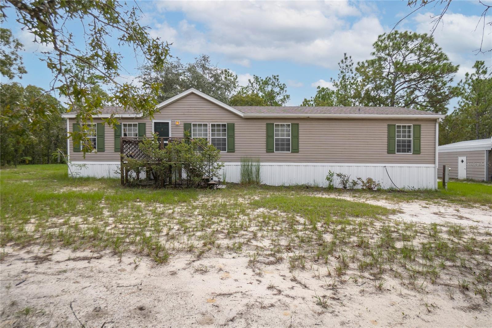 Check out this MOVE-IN READY 3/2 1,500+ sq.ft. home nestled on a FULLY FENCED 2.5 acre parcel equipped with covered rear deck, HOT TUB, WORKSHOP (with loft storage, separate sub-panel box, side entry, and 8' front rolling door), carport, firepit, and yes even an eclectic outhouse. NEW ROOF in 2019! Conveniently situated within a 15-min drive of Crystal River, the Withlacoochee Trail, shopping, and medical facilities. No HOA or deed restrictions! Bring your toys, RVs, boats, horses, livestock, or projects. High-speed internet is available! Call today for a personalized tour of the home, workshop, and property.