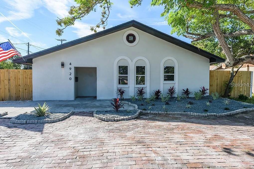 Completely remodeled & move-in ready! This 3BR/2BA home features soaring cathedral ceilings, tons of natural light, new kitchen with granite & soft-close cabinets, fully updated baths, new flooring, tankless water heater, updated electrical, fresh landscaping, and a fenced yard perfect for pets or entertaining. Oversized 2-car garage can convert to in-law suite. Renting out for $3,085/month, making it a perfect turnkey investment or personal residence. Just 15 min to beaches & downtown St. Pete—furniture conveys!