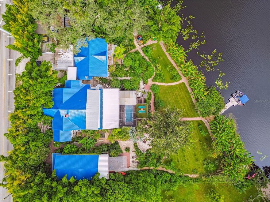 A FAMILY SANCTUARY ON THE HILLSBOROUGH RIVER! Imagine your entire family living side by side, each with your own space, yet united on one remarkable riverside parcel in the heart of Tampa. Elevated high on a hill in FLOOD ZONE X—protected and untouched through recent hurricanes due to its natural elevation, downriver flow of dam protection—this rare estate is designed for those who value FAMILY, SELF-SUFFICIENCY, AND LIVING OFF THE LAND TOGETHER. Here, four unique dwellings come together to form a true MULTI-GENERATIONAL RETREAT: A COUNTRY-STYLE COTTAGE with two bedrooms, two baths, and dual kitchens—perfect for shared meals and family gatherings, A THREE-STORY BUNGALOW with three bedrooms, three baths, a rare basement for storage and canning, plus a sauna and swim spa for wellness and relaxation, A STUDIO LOFT with soaring ceilings and kitchenette, ideal for a young adult, in-laws, or creative retreat, A RIVERSIDE COTTAGE/BOAT HOUSE, a cozy escape with compost facilities, perched right at the water’s edge. LIVING IN HARMONY WITH NATURE. Stroll the winding pathways that connect each home through your own BOTANICAL GARDEN-STYLE LANDSCAPE. The property overflows with fruit trees, herbs, and vegetables—bananas, papayas, mangos, guava, jackfruit, dragon fruit, figs, mulberries, sugarcane, cassava, spinach and curry trees, and so much more. Wildlife flourishes here, with the Hillsborough River flowing quietly at your doorstep. A RESILIENT LIFESTYLE. This is more than a home—it’s a SANCTUARY FOR THE FUTURE. From the basement prepped for secure storage and canned goods, to composting facilities and thriving gardens, everything is built for INDEPENDENCE AND SUSTAINABILITY. Yet, you’re only minutes from shops, dining, I-275, and the best of Tampa. A RIVERFRONT HAVEN. Launch a boat from your backyard and cruise directly to LETTUCE LAKE PARK, or enjoy serene evenings overlooking the water. Across the river, a golf park preserves your view of untouched greenery, ensuring your daily backdrop is nature itself. FOR FAMILIES DREAMING OF LIVING CLOSE, GROWING TOGETHER, AND CREATING A RESILIENT FUTURE IN HARMONY WITH NATURE, THIS HILLSBOROUGH RIVER COMPOUND IS A ONCE-IN-A-LIFETIME OPPORTUNITY.