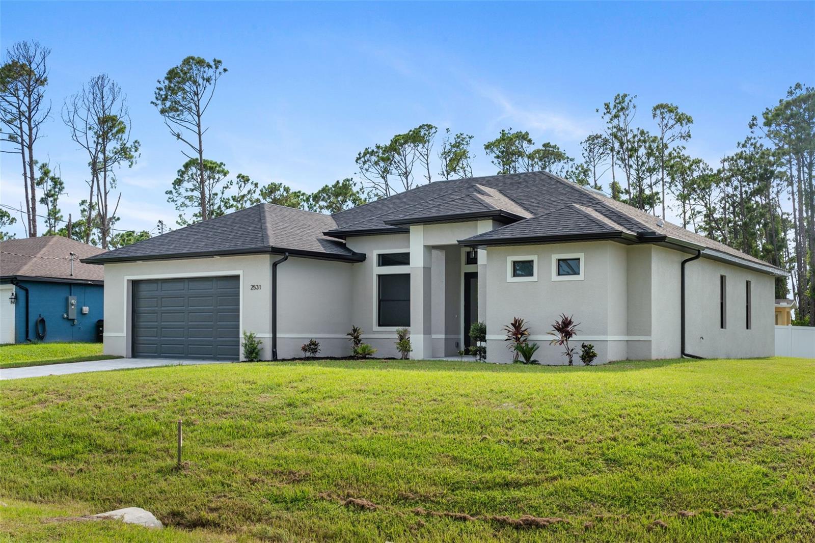 MOVE-IN-READY and brand new, nestled on a quiet and serene corner lot in the City of North Port. Three (3) bedrooms, two (2) bathrooms, a French-door, glass entryway both out front and in the den, full size laundry room, and more are waiting for you to call it your very own slice of Florida sunshine. All quartz countertops in wet areas, soft-close shaker style cabinetry, paver driveway, hurricane-impact windows and doors, expanded halls, trayed ceilings, high-end LG appliance package, dual closet-sink-shower in master rooms, are just a few of the luxurious features and the list goes on and on. Some additional considerations on this home include a nest thermostat coupled with a recessed A/C unit to add even more space in the expansive garage, an extended driveway for additional parking space, and this home is located where NO flood premium is necessary meaning savings for you! Come schedule a private viewing and make your Florida dream home and life, become your reality.