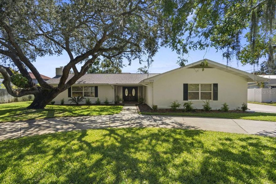 Looking for a move-in ready, one-of-a-kind Dunedin block home?  Look no more!  This mid-century 3BR/2BA pool home features both 2-car AND 3-car garages!!!  It sits on a 1/3 acre lot in a NON flood, NON evacuation zone on a dead end street with sparse traffic.  Plus, the neighborhood is in unincorporated Dunedin with NO HOA.  It is conveniently located just off the beaten path yet near everything!  Home has easy access to major thoroughfares leading to supermarkets, restaurants, major shopping hubs, Westfield Mall, Dunedin Beaches, and the Historic Downtown District.  The home has a captivating curb appeal with a dramatic oak tree, circular driveway, large parking pad, covered front porch, and double door entrance.  The interior offers a bright, spacious, split bedroom plan with oversized rooms, triple glass sliders, 3 sets of exterior French Doors, dual A/C systems, dual water heaters, and workbenches in both garages... Upon entering, you're greeted with a large central foyer adjacent to two interior living areas and French Doors leading to a relaxing ouitside living space.  The floor plan includes: large living room with triple sliders to lanai, oversized kitchen with casual dining area, spacious master suite with double ceiling fans & French Doors to lanai, huge master bath with double vanities - walk-in shower - walk-in closet & private toilet, roomy guest bedroom with French Doors to lanai, office or 3rd bedroom with built in shelving, updated hall bath, laundry room, pool bath and access to both garages.  The abundant indoor & outdoor living spaces with refreshing pool make this home PERFECT for entertaining.  Updates include: KITCHEN: cabinets, counters, hardware, backsplash, under cabinet lighting, double sink & faucet, MASTER BATH: double vanities, lighting & custom tiled walk-in shower with benches, HALL BATH: double showerheads, custom tiled walk-in shower & glass enclosure, INTERIOR: ceiling fans, crown molding, window blinds, recessed lights & French Doors to master bath, EXTERIOR: lanai ceiling fan, screened enclosure, well sprinkler system, PLUS a newer roof (2022).  This home also allows you to enjoy countless amenities the area offers: beaches, parks, casual & fine dining, roof top bars, micro-breweries, cafes, bike riding, boating, fishing, downtown festivals, concerts, art shows, spring training baseball, championship golf, sunsets, and events at the Community & Fine Art Centers.  This is a MUST SEE for buyers seeking a unique home with lots of extras in an ideal location.