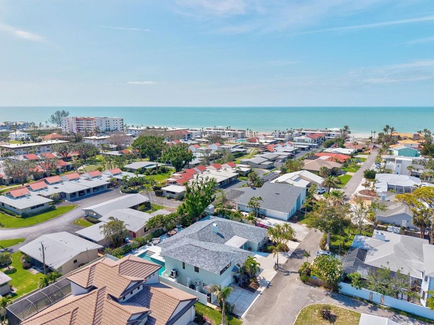 Where else can you find a home of this size, offering this level of quality, only 250 yards from the Gulf of America at this price? Enjoy private,
gated beach access just steps from your front door in this meticulously renovated 6 bedroom, 4 bath island home, being sold FULLY FURNISHED complete with an air conditioned garage, located on the island of Venice only seven homes from the Gulf of America. From the moment you arrive, the curb appeal makes a statement, featuring a freshly painted exterior, manicured landscaping, and a circular driveway. Combined with the attached garage and extended side driveway, there is abundant parking for vehicles, boats, and RVs. This home was unaffected by last year’s hurricanes and is located outside of a flood zone, meaning flood insurance is not required. The backyard is a true private oasis, highlighted by a heated custom pool, a beautiful marble deck, and a fully equipped second kitchen with direct access through sliding glass doors off the pool area.
A majestic banyan tree shades the expansive patio and walkways, creating an ideal setting for large gatherings and outdoor entertaining. Inside, the remodeled kitchen is designed for both beauty and function, featuring stainless steel appliances, upgraded soft close wood cabinetry, granite countertops, and an oversized island that flows seamlessly into the open concept family room and spacious dining area. Just off the double door entry, a second living space provides a warm and inviting retreat, complete with a charming fieldstone fireplace. The secluded primary suite offers exceptional privacy, featuring a large walk in closet and a spa inspired ensuite bathroom with high end finishes. On the opposite side of the home, the main level includes three additional bedrooms, two bathrooms, and a secondary kitchen, perfect for poolside entertaining or multi generational living. Upstairs, two generously sized bedrooms share a remodeled Jack and Jill bathroom, offering flexible space for guests or extended family. This home has been completely transformed with modern upgrades throughout, including new electrical and sewer lines, a new roof, updated air conditioning system, and enhanced pool and deck features. A new irrigation well and irrigation system have also been installed. Whether you are enjoying breathtaking sunsets from your heated pool and patio or taking a short walk to your private beach access, this home captures the essence of Florida island living. Located in the heart of Venice, you are minutes from the Venice Fishing Pier, historic downtown Venice with its unique shops and dining, Venice Beach known for shark tooth hunting, and the scenic Legacy Trail for biking and walking. If you have been dreaming of the Florida island lifestyle with ample space to entertain family and friends, this custom home on a quiet, private street just steps from the ocean is your opportunity. Start living your Florida dream today, and be sure to explore the 3D Matterport Tour.