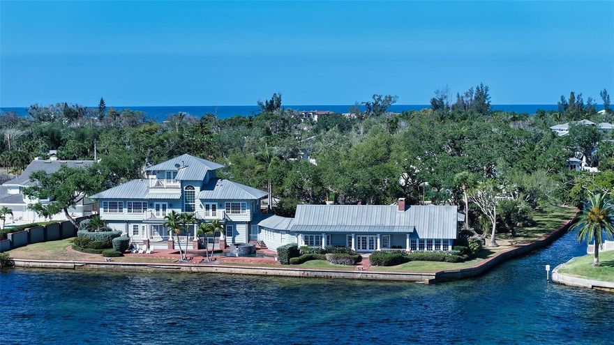 Rarely does a property of this caliber become available on Siesta Key. Spanning approximately 1.6 acres, this exceptional waterfront estate is framed by majestic oak trees and lush, mature landscaping, creating a private, quiet, and timeless retreat. This legacy property showcases expansive bayfront views that wrap gracefully around to a protected canal, offering both breathtaking vistas and sheltered water access. At its heart stands a classic and formal Southern-style residence, remodeled in 2008, rich in character and designed for an elegant lifestyle. Grand, beautifully proportioned rooms are designed for effortless entertainment, highlighted by a stately formal dining room worthy of the most important occasions. The expansive country kitchen is both functional and refined, featuring a professional-grade Wolf range with custom copper hood, an oversized Sub-Zero refrigerator, vintage tile flooring, and a striking chandelier that brings a touch of timeless elegance to space. A classic wood-burning fireplace adds warmth and character to the cozy wood paneled den with charming French doors opening to bayfront views. With six spacious bedrooms, six full bathrooms, and two additional half baths, this home offers exceptional comfort and ample space to accommodate family and guests with ease. Car enthusiasts will appreciate the 8 garages.  Boaters will appreciate the ample opportunities to enhance this property with custom docks or lifts. For those envisioning a custom estate, the property also offers a rare opportunity to build your dream home while comfortably residing on-site in the charming guest cottage, complete with bedroom suite and kitchen—allowing you to plan, design, and construct at your own pace without ever leaving this exceptional setting. Additionally, the property can be split into 3 separate waterfront parcels with the smallest water frontage being 99 ft. This is a true legacy offering, where expansive space and stunning waterfront beauty come together seamlessly, enhanced by breathtaking views that elevate every moment in this extraordinary setting. The Sanderling Club, the only guard-gated, single-family neighborhood on Siesta Key, offering residents  tennis and pickleball courts, playground, and deeded access to a pristine stretch of Siesta Beach. Located minutes from Siesta Village, this property provides the perfect balance of serene seclusion and proximity to Sarasota’s vibrant cultural and culinary attractions.