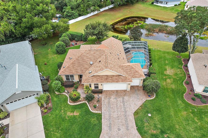 Fabulous 3/2 CBS Dogwood/Jasmine with a Gas Heated Salt Water POOL, SPA,  2 Car + Golf Cart Garage on nearly 1/3 acre PRIVATE Lot with plenty of room to expand in the Village of Woodbury, Spectacular Outdoor Living Space, Overlooking Seasonal Water View, BOND PAID, Large Eat In Kitchen with GAS Cooking, Tile Backsplash, Breakfast Bar, Upgraded Cabinets with under and over counter lighting, Newer Upgraded GE Profile Stainless Appliances, Quartzite Counters, VAULTED CEILING, OPEN FLOOR PLAN, Large Dining and Living Areas, Large Florida Room, Tile Flooring throughout, Primary Bedroom with Custom Walk in Closet, Updated/remodeled En Suite with Walk in Shower, Double Sink, Granite Counter, Comfort Height Toilet, INSIDE LAUNDRY, Bedroom 2 with closet and sleeper sofa, and Bedroom 3 with closet and Murphy Bed, Updated/Remodeled Guest Bath with Tub/Shower, Spectacular Outdoor Living Space with Gas Heated Salt Water Fiberglass Pool (refinished 3 years ago), Spa, Natural Gas for Grill, Firepit Area, Fountain, overlooking Seasonal Water View with wonderful wildlife, PRIVACY, Lanai rescreened and floor painted 2021, Bathrooms remodeled 2023. Other Great features include 5 Solar Tubes, CROWN MOLDING, New Blinds, Surge Protector, Paver Driveway,  Decorative Glass Front Door, Exterior Painted 2 years ago, Hideaway Screen on Front Entrance,  Nest Thermostat, High End Washer & Dryer, 2 Car + Golf Car Garage with Epoxy Floor, Room for 2 Cars + 2 Golf Cars, Upgraded Landscaping with LED lighting, Roof Replaced 2020, HVAC 2020, WH 2019.  Located in the Quiet and Highly Desirable Village of Woodbury, near Highways 441/27 & 42 with endless Shopping & Dining options (3 Publix stores, ALDI, Walmart, Winn-Dixie, Target, Lowe’s, Home Depot, & More); a short drive to Spanish Springs Town Square; the new First Responders Rec Center with Resort-Style Pool, Pickleball, Tennis, 18-Hole Putting Course, Basketball, Croquet, Corn Toss, & More; numerous Championship Golf Courses & Country Clubs (Nancy Lopez Legacy, Glenview Champions, Hacienda Hills, Tierra Del Sol); Executive Golf Courses (Briarwood, Walnut Grove, Oakleigh, Amberwood, El Diablo, El Santiago); and Regional Rec Centers (Mulberry Grove, Savannah, & La Hacienda). PLEASE WATCH OUR VIDEO OF THIS SPECTACULAR POOL HOME WITH SEASONAL WATER FRONT!