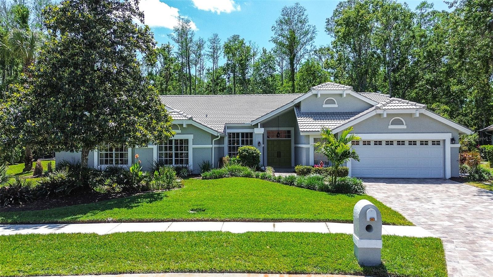 Welcome home to the quaint 22 home enclave of Greenhaven II featuring spacious home sites w/ an abundance of green space securely located within desirable gated East Lake Woodlands. This spacious 2,888 Sq Ft residence with Total 4,210 Sq Ft Area features 4 Bedrooms / 4 Bathrooms / 2 Car Garage / Heated Pool Spa / Open Concept Split Floor Plan. The home is set on a landscaped, .57 acre premium lot with private green space views. This highly appointed home features a remodeled look/feel with consistency of materials, flooring, and high design throughout. Quality of construction is apparent with a replaced tile roof, freshly sealed brick paver driveway. Entering the double door foyer, you are welcomed by a formal living room with views of an expansive brick paved lanai and backyard w/ panoramic view. A spacious formal dining room with nearby hallway custom shelving and cabinets. The light/bright, open concept Great Room/Family room and Chef's Kitchen space perfect for everyday living/entertaining features: soaring high ceilings, accent windows, custom enclosed shelving, wood burning fireplace, continuous transom windows w/ sliding glass doors. The Chef's kitchen includes a large walk-in pantry complete w/ shelving, and a separate casual dining area. Kitchen features Stainless steel appliances, double ovens, huge island with cook top, counter seating, large quartz countertop spaces, wood cabinetry, a large kitchen sink area with designer backsplash, and a convenient pass-through service counter area w/ window views to the outdoor lanai space. The outdoor lanai space features and an exceptionally spacious covered outdoor dining area, large in ground pool and spa, and freshly sealed brick pavers. An outdoor cabana area includes a full bathroom w/ shower, and countertop food/beverage service area complete with sink, electric and storage cabinets. The Primary Bedroom Suite is private and spacious featuring a separate lounging seating/desk area with windows, double slider doors and private green space views. Enjoy the use and convenience of a huge walk-in wardrobe room with custom shelving and pull-out draws. The Primary Suite bathroom features high design quartz, wood cabinetry, double sinks, frameless glass shower, and a luxurious free-standing bathtub. The spacious Bedroom 2 features a large closet and an adjacent updated high design full Bathroom. Bedrooms 3 & 4 are complete w/ large closets and share an updated full "Jack and Jill" bathroom. Bedroom 4 can also be used be as an en-suite that is perfect for Guests, In-Law Suite, or a private Home Office/Flex space. A separate Laundry Room is complete with Washer/Dryer, lots of built in storage cabinets, and a convenient laundry tub sink. The Oversized 2 car garage includes lots of storage space, a separate walk-in closet, owned water softener, and new exterior service door. Located near everything and within one the Tampa Bay Area's premier Golf, Tennis and Country Club Communities. Optional membership at the on-site ARDEA Country Club feature many available amenities including Golf, Tennis, Pickle Ball, Lap Pool, Fitness Center, Restaurant, Social/Holiday and Private Events for your family and guests. Live within minutes of Top-rated Health Care, Top-rated Schools, Airports, Shopping, Restaurants, Micro Breweries, Beaches, Marinas/Boating, Waterfront Towns, Arts, Entertainment, and the renowned Tampa Bay Professional Sports Venues. No Flood Insurance required. A must see today!