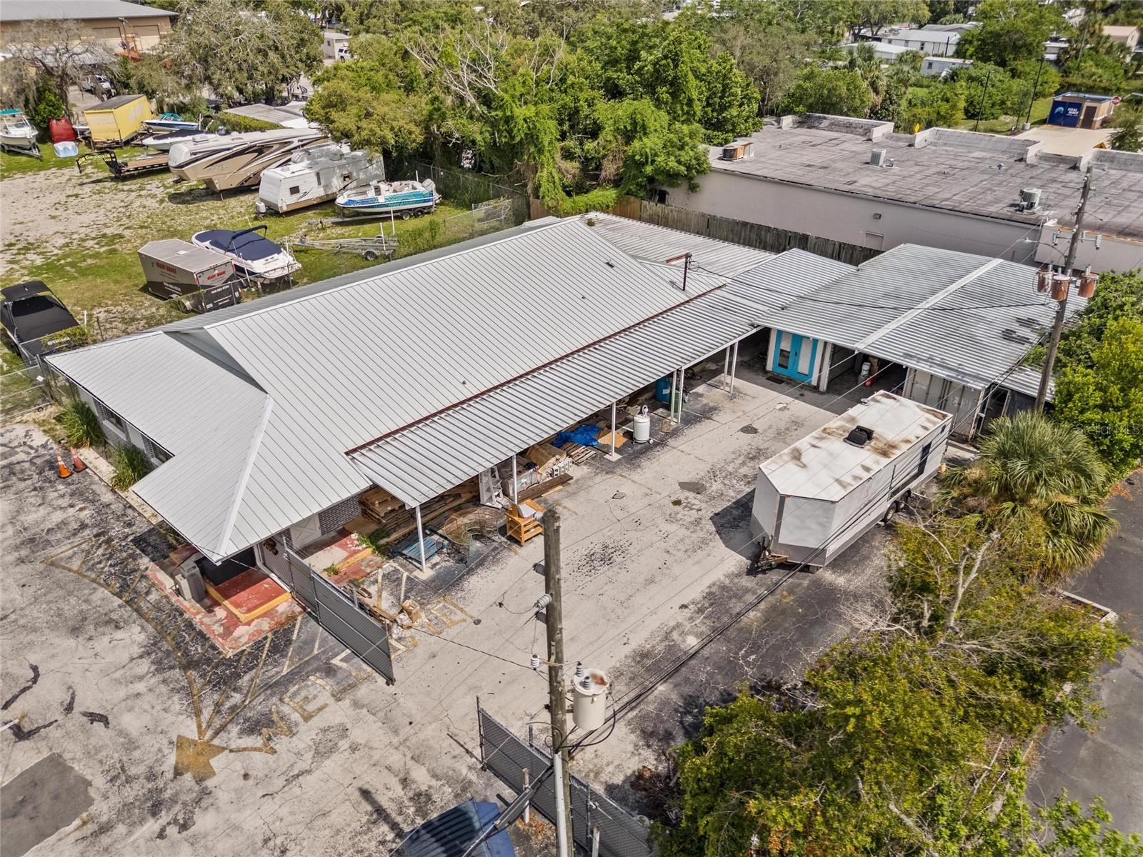 Over 1 Acre of commercial and industrial land on the Pinellas/ Pasco County line and situated a stones throw to US Highway 19. This property has a magnitude of uses for just about anyone. Currently being used as warehouse/ storage, theres about a 5,000 sqft building with a fenced in parking lot, another 1/2 acre that has access onto Precision Rd which is being used for storage of boats, trucks, trailers, RVs etc.. This is set up as self storage and these tenants pay monthly to store their property. Additionally there is a small shop keeper house that has been nicely re done and could be rented out monthly. Excellent ingress and egress and close proximity to US 19. This neighborhood is primarily composed of like kind industrial, commercial and warehouse type uses. Properties like this are becoming increasingly hard to find.