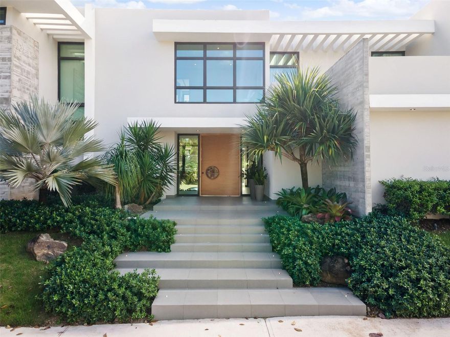 Located in Guaynabo’s exclusive Garden Hills North neighborhood, this impeccable home with close to 6,000 sqft of meticulously designed living space defines the concept of turnkey, ready-to-move-in perfection. Every inch of this masterpiece has been thoughtfully crafted with the utmost attention to detail by renowned interior designer, Gretchen Daubon. The renowned Jota Arquitects firm is responsible for the architectural genius at the rear of this house, which guarantees a tasteful fusion of style and utility.

This is a new construction that underwent a complete demolition and reconstruction, leaving no stone unturned in the pursuit of perfection. The 3-car garage offers ample space for your vehicles, with room to mount 3 more on top for the avid collector.

Upon entering, you'll be greeted by soaring high ceilings and sliding doors that effortlessly connect the opulent outdoor environment with the interior areas. Top-tier fixtures and finishes from Copat, an Italian brand known for luxury, adorn the kitchen, bathrooms, and closets. If you love hosting gatherings, you'll adore the dedicated entertainment area, featuring a billiard table, a chic wet bar, and a cozy living room, perfect for movie nights or karaoke parties.

Ascending to the second floor, you'll find a cozy sitting area leading to the grand master bedroom. The master suite has a lavish master bathroom with a beautifully designed his and hers vanity, an open shower, and an inviting bathtub. The master closet is expansive, offering ample space for all your belongings. Three additional generously-sized bedrooms, each with its own ensuite bathroom, complete this level.

Go outside to the beautifully designed patio, where you can unwind by the or take a dip or lounge in the pool. The terrace is a tranquil haven for alfresco dining and leisurely sitting.

This isn't just a house; it's a statement of luxury and sophistication. Every detail has been carefully chosen to offer the finest in high-end living. Don't miss the opportunity to own this luxurious piece of Garden Hills North.
