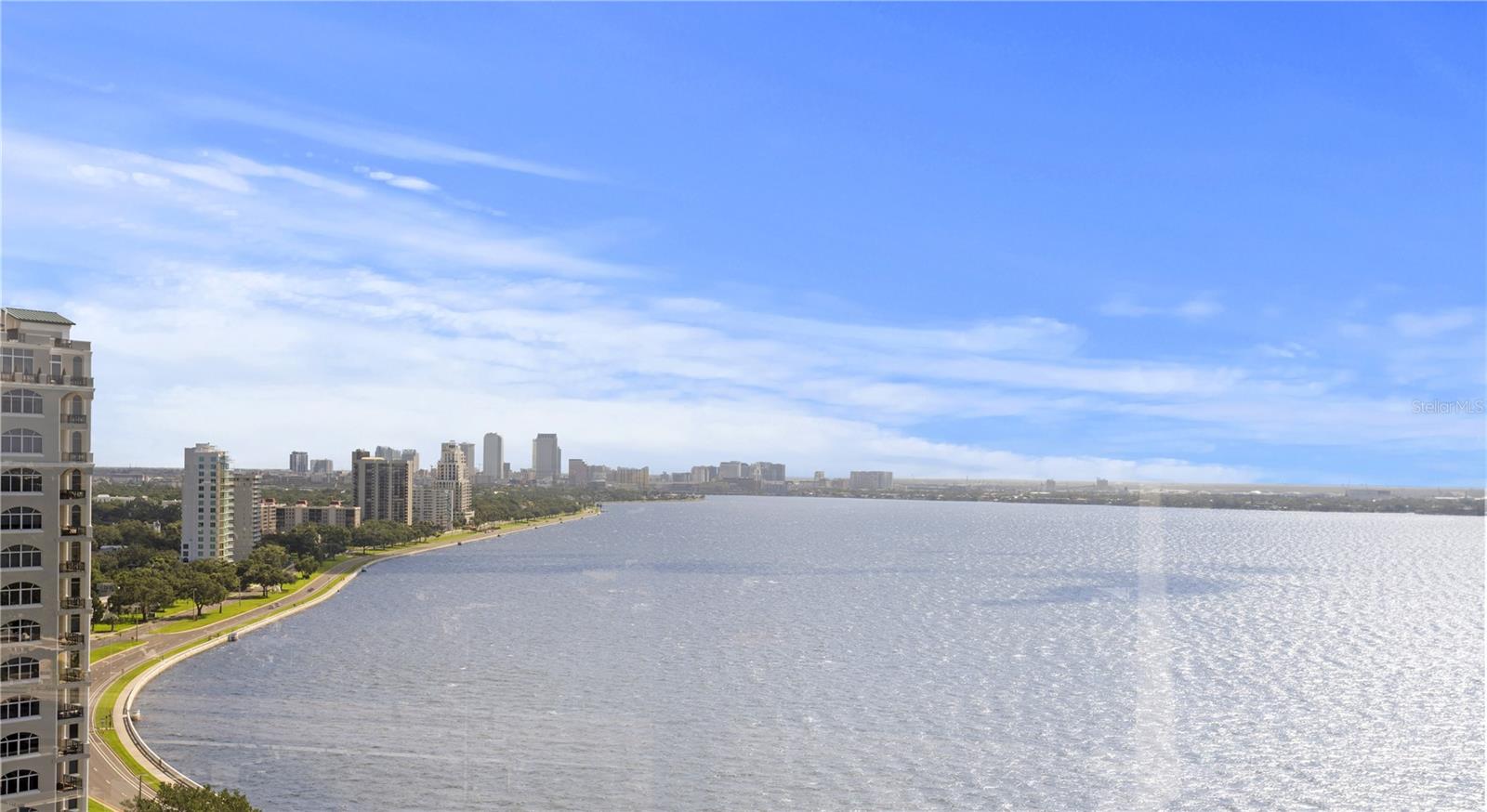 Impeccably maintained and completely renovated, unit in the prestigious Monte Carlo Towers with breathtaking views of the Bay and downtown Tampa! Step through double doors into a spacious foyer leading to an open-concept living, dining, and kitchen area—showcasing panoramic vistas through floor-to-ceiling windows with automatic shades. This sophisticated condo features wide plank hardwood flooring throughout the foyer, living, dining, kitchen, and bedrooms. The custom kitchen is a chef’s dream—solid wood cabinetry with soft-close drawers, Quartz countertops, spice cabinet, beautiful tile accent wall and backslash, stainless steel appliances, large island with pendant lighting and storage, a custom walnut seating area, walk-in pantry, and a private trash chute! The spacious primary suite offers wood floors, ceiling fan, ensuite with dual sinks, luxurious walk-in shower with built-in bench, porcelain, and pebble flooring. The second bedroom features wood floors and an oversized wall-to-wall closet with a closet system. The second bathroom continues with the high-end finishes - custom cabinetry with single sink, walk-in shower, and travertine flooring. Additional highlights include laundry closet just off the kitchen (washer and dryer 2020), all interior doors and hardware replaced, surround sound in the living room, all new lighting throughout, newer stove and microwave (2020), popcorn ceilings removed and 2 storage spaces. Monte Carlo Towers is known for its luxury and exclusivity, offering a grand 24,000 sq. ft. lobby with marble floors, five elevator towers with semi-private lobbies (only two units per floor), and resort-style amenities. Residents enjoy two guest suites, a heated pool, outdoor grills, a social room with a full commercial kitchen, a library, a gym with saunas, and two tennis/pickleball courts. Security and convenience are paramount with 24-hour concierge service, secured resident and guest parking, and onsite management. Ideally located just minutes from premier dining, shopping, cultural attractions, sporting events, major highways, award-winning beaches, and both Tampa International and St. Pete/Clearwater airports, this residence offers the best of Tampa Bay living. Call today to schedule your private showing!