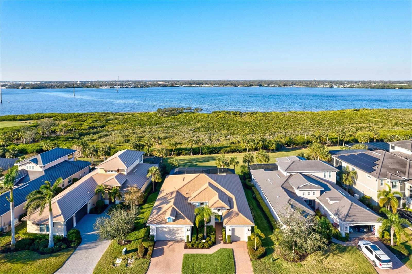Waterfront property alert! This welcoming home sits by the water, the Manatee River that stretches out in the back of the house like an old friend you’ve known your whole life. Each day you get the gift of watching boats pass to and from. The Gulf and its beaches are near where the white sand and warm Gulf waters welcome your toes. If you’re a boater, this community offers a beautiful marina. This house is a hop, skip and a jump to the marina where a slip awaits you, where you can hop on your boat for a quick adventure on the water. Â
Nature surrounds the place, making it feel like a world unto itself. Inside, the ceilings are high, the kitchen is made for cooking, and the pantry is big enough to hide a few secrets. The counters are natural stone granite, and the island is long enough for creating meals while having conversations with family and friends. The kitchen is open to the family room and the lanai, both spaces offering you a place to relax after a long day. The rooms are big too, with space for everything you need. The master bedroom is made for comfort, with a closet so large you’ll get lost in it. There is an office space, a perfect place for you to check things off of your productivity list along with an open dining room space... another wonderful place to make memories with family and friends. There’s a laundry room with a sink, counter space for folding, and cabinets for all the things you want to store.Â
You’ll like the lanai. It’s perfect for coffee in the morning or a drink at night while you watch the boats and the wildlife pass by. The saltwater pool is there for you when you’ve had enough of the boat or the beach. After a day on the water, it’s the perfect place to cool off. The garage is big enough for three cars, and the house is built to last, with hurricane shutters to give you peace of mind.Â
The community offers a marina, two clubhouses, dog parks and a pool that’s like something out of a dream. There’s a gym, a place to meet people, a kitchen for when you want to cook for a large number of guests, and a social room where the conversations flow as easy as the drinks. Outside, you have tennis courts and a canoe and kayaking launch, free for use. There’s even a nature trail along the river. Tidewater Preserve is a gated community with a Gate Guard's presence 24/7. It is in an excellent location, the lawn’s always green, and there’s a lifestyle director to help make sure everything runs smooth. All of it’s here, in Tidewater Preserve, at a cost that won’t make you blink twice. No CDDs, no surprises. Come see it. Feel it. And if it feels right, make it yours.