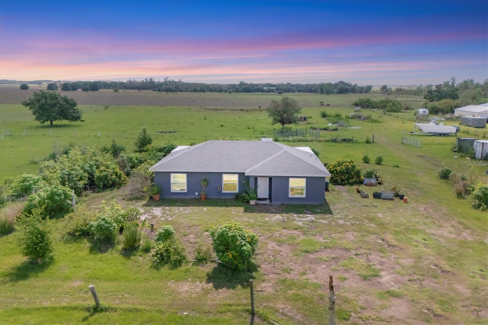 MOTIVATED SELLER OFFERING $5000 TO BUYERS CLOSING COSTS OR INTEREST RATE BUY DOWN!
Charming 3 bed, 2 bath home on over 6 acres, built in 2021! Welcome to your private retreat! This beautifully maintained 3-bedroom, 2-bathroom home sits on over 6 fully fenced and cross-fenced acres, offering the perfect blend of comfort, functionality and space. Built in 2021, the home features modern systems throughout - including the roof, AC, septic, and well, all just a few years old. Inside, you'll find beautiful granite countertops, stainless steel appliances and a dual sinks in the primary bathroom, combining style and functionality. The open floor plan flows seamlessly onto a large covered back patio.Enjoy peaceful country living with standout outdoor features such as a 30x30 pole barn, 2 20-foot storage containers, and a spacious, approximately 15x50, covered back porch - ideal for entertaining or relaxing while overlooking your land. The property is gated for added privacy and security, making it ideal for livestock, equipment, or simply enjoying the open space. Whether you're looking for a full-time homestead or a peaceful weekend getaway, this property offers endless potential and room to grow.