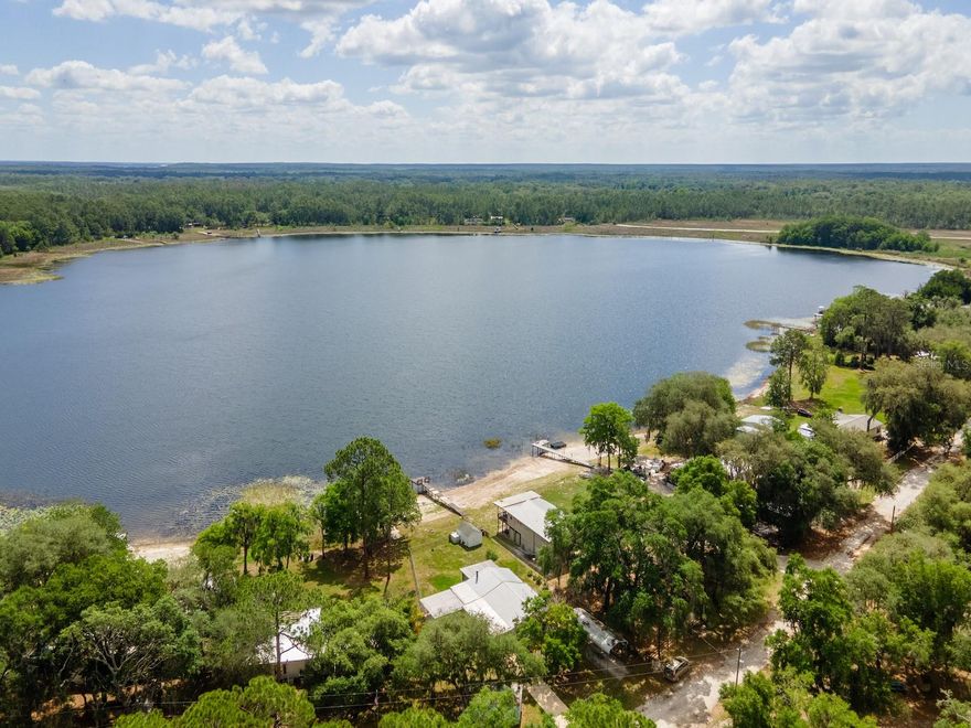 23191 NE 112 Court Road Fort McCoy, FL 32134: Your Slice of Paradise on Deerback Lake

Wake up to the tranquility of lake life in this charming 2-bedroom, 1-bathroom concrete block home, perfectly situated on the beautiful, spring-fed Deerback Lake. With approximately 62 feet of prime lake frontage and a lot size of 0.41 acres, this property offers a peaceful escape with room to enjoy the outdoors.

Interior Highlights (1,060 Living Sq. Ft.):
Lake Views: Enjoy the stunning waterfront scenery year-round from the enclosed, 180-square-foot Florida Room, located just off the living area and boasting large windows.
Living Space: The cozy living room features a warm, wood-burning fireplace and French doors that lead directly to the screened room.
Kitchen & Dining: The kitchen includes a dedicated dining area, a lovely bay window, all appliances, and ample cabinet and countertop space for storage and meal prep.
Bedrooms & Bath: Both bedrooms are nicely sized, and the shared bathroom includes a tiled shower and single vanity.
Convenience: The home also includes an inside laundry and storage room.
Outdoor & Property Features (1,806 Total Sq. Ft.):
Outdoor Living: A spacious screened porch in the back is the perfect spot to enjoy magnificent sunrises with your morning coffee/tea and relax during the late afternoon twilight sunsets. The total square footage includes this screen room, the Florida Room, an attached 1-car carport, and a 17x17 covered patio.
Storage & Parking: In addition to the attached 1-car carport, the property features a detached metal 2-car port and two nice-sized storage sheds, offering plenty of space for vehicles and all your lake toys.
Yard: The backyard is fully fenced, providing a secure area for pets or play.
Area & Lake Information

Deer Back Lake Details

Deer Back Lake is a 78.85-acre lake in Marion County, Florida, known to be spring-fed and picturesque. It is a popular spot for fishing and water activities.

Location & Amenities
Fort McCoy: Located only 15 minutes from downtown Fort McCoy, you have convenient access to a grocery store, doctor's office, pharmacy, hardware, gas station, pizza, and more.
Shopping & Dining: Take a short drive to Silver Springs, which includes major retailers like Walmart, Lowes, Bealls, Outback, and many more of your favorite shopping spots and restaurants.
Ocala: Ocala is only another 10 minutes from Silver Springs, offering a vibrant nightlife and lots of entertainment options and restaurants.
Gainesville: Gainesville (Home of the Florida Gators) is only 50 minutes to downtown.
Outdoor Enthusiast's Dream

If you’re a fisherman, or hunter or simply love hiking, canoeing or kayaking you are in luck! Minutes to Ocklawaha River, Ocala National Forest, and many natural springs (Salt Springs, Silver Glen Springs, Juniper Springs), horseback and walking trails, and off-road vehicle trails await your explorations.

One-of-a-kind property and location! Ready for new owners!