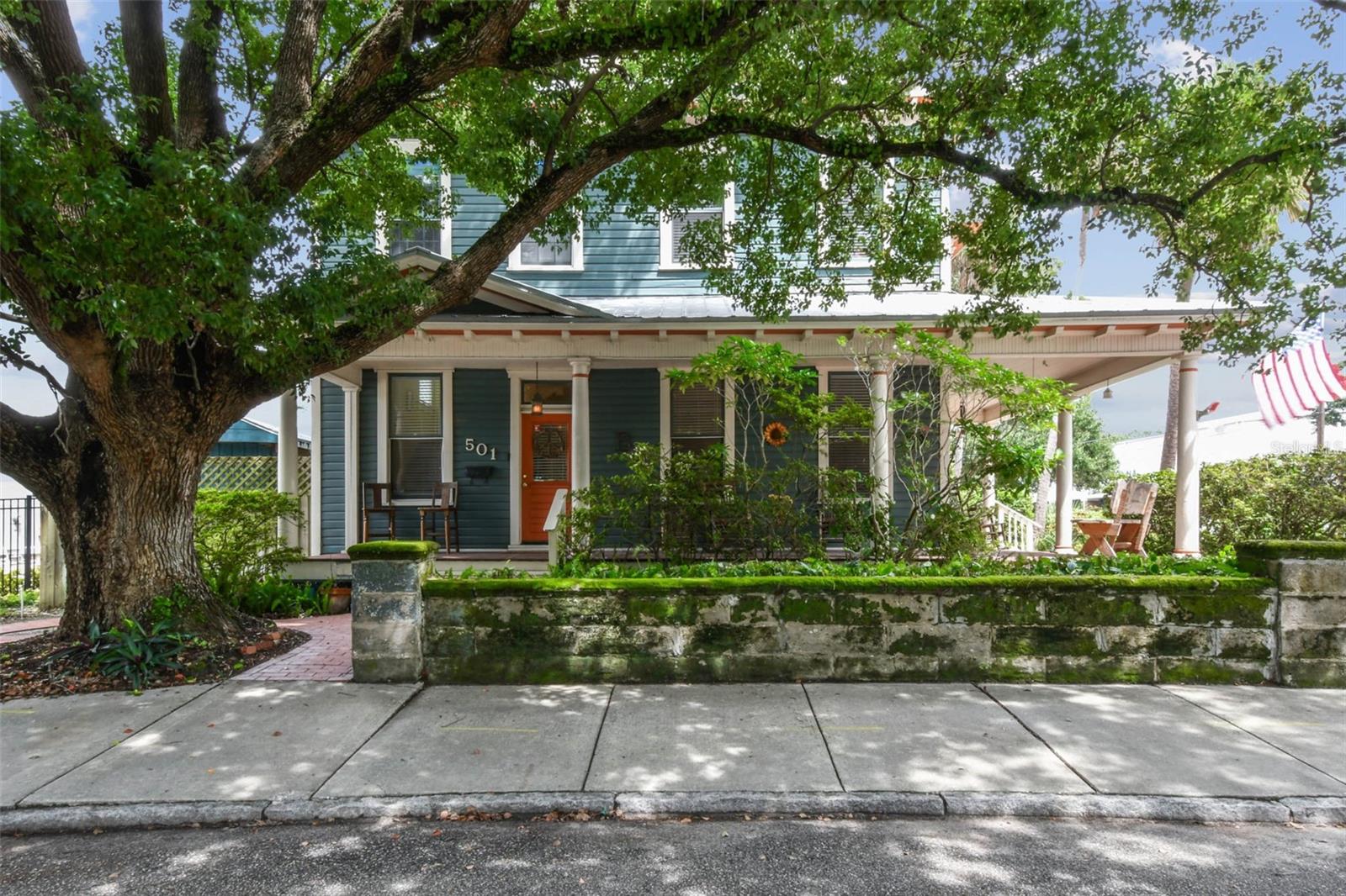 Welcome to this beautifully preserved 1913 home located in the heart of highly sought-after Tampa Heights. Nestled on a picturesque 75 x 109 corner lot, this historic residence blends timeless charm with thoughtful updates-perfectly suited for those who appreciate character and vintage ambiance. From the moment you arrive, the curb appeal is undeniable. A stunning wraparound porch invites you in, offering the ideal spot to relax under the shade of majestic trees. The back yard is fully fenced, features large double gates, providing secure access, ample parking, a covered carport (that may double as an outdoor patio), and a newer solid shed with hurricane straps. This home has been lovingly maintained. A durable and long lasting metal roof (2006), a newer HVAC unit (2022/2023), and a commercial-grade tankless water heater (2018/250k BTU's) ensure comfort and efficiency. Step inside to find a grand entryway full of light that leads to a spacious dining room and an expansive living room with gas fireplace-ideal for entertaining and holiday meals. The retro-style kitchen features newer appliances, a built in table and bench duo. Downstairs you will also find a laundry room and a full bedroom and bathroom for added convenience and flexibility. Climb the impressive staircase to find 3 bedrooms, 2 of which are generously sized, a large full bath, and access to a fully insulated attic, already plumbed for an additional bathroom. The attic may easily be converted into a private retreat, a studio, or more living space. Tampa Heights offers unbeatable location perks. Head South and you are minutes from Armature Works and Downtown Tampa. Go North for quick access to vibrant Riverside Heights and trendy Seminole Heights. I275, I4, Ybor City, Port Tampa, the Channelside District and more are a short drive away. Don't miss this rare opportunity to own a piece of Tampa's History-with all the updates needed to enjoy it for years to come.