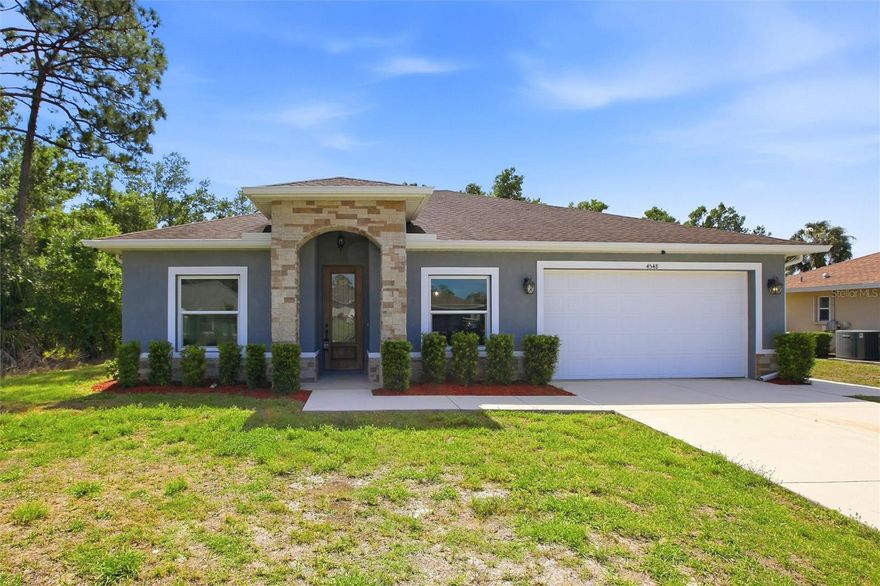 Welcome to this 2018 custom built home offering 1,785 square feet of thoughtfully designed living space in the heart of North Port, set on a quiet street and ideal for everyday comfort and easy entertaining. The split floor plan provides both privacy and functionality, with luxury vinyl plank flooring throughout the main living areas and tray ceilings adding depth to the space. Hurricane impact windows and sliding glass doors are installed throughout, with the exception of the front entry door. The layout opens from a formal living and dining area into the main living space, where the kitchen and family room connect seamlessly. The kitchen features espresso shaker style wood cabinetry with crown molding, Carrara style quartz countertops, a classic subway tile backsplash, and a full Maytag stainless steel appliance package, along with an undermount sink, recessed lighting, and pantry storage. Extending from the main living area, sliding glass doors open to an additional enclosed space ideal for use as a Florida room, bonus room, or flexible entertaining area, which then leads out to the rear patio. The primary suite is privately positioned and includes a spacious layout with tall, elongated windows that bring in natural light while maintaining privacy, along with a walk in closet with built in organization and an en suite bathroom featuring dual vanities with quartz countertops, framed mirrors, updated lighting, and a frameless glass walk in shower with black hardware, large format tile, and built in shelving. Two additional bedrooms share a full bathroom with coordinating finishes. A laundry room with utility sink and garage access adds convenience. The backyard offers space for outdoor seating or a future pool while remaining easy to maintain. Located with easy access to I 75, this home is within a short drive to Manasota Key, Venice Beach, and Englewood Beach, as well as shopping, dining, and nearby airports. The home is serviced by a private well and septic system, with the septic system properly maintained and pumped and the HVAC system regularly serviced, offering added confidence in the overall upkeep of the property. **PLEASE ENJOY THE 3D INTERACTIVE VIRTUAL TOUR ASSOCIATED WITH THIS LISTING**