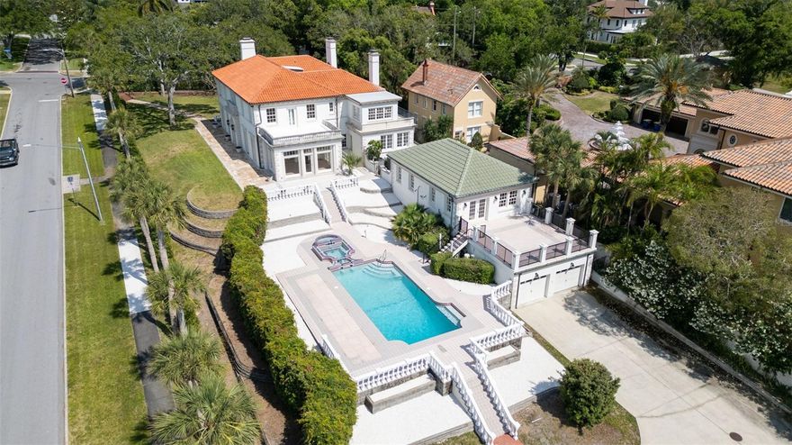 House NOT affected by recent flooding.  Be the one to own this historic masterpiece located high on the bluffs overlooking Clearwater Harbor in the sought-after Harbor Oaks area.  Its beauty provides a historical classical Mediterranean street view when you first approach.  The entrance is through a beautiful antique Tiffany glass door leading to a majestic center hall with a grand stairway to the upstairs with a classic wrought iron banister and railing.  The floors throughout are beautiful oak and maple wood finished in a light blonde natural color.  The kitchen is marble and the sunrooms are stone and terrazzo.  The kitchen is ready for the chef with all appliances and a connected pantry.  There is also a mud room at the rear access to the house and a connecting hallway to the dining room for grand affairs.  The grand stairway leads to an upstairs surround balcony with matching wrought iron railing.  All 5 of the bedrooms access from the surrounding hall balcony.  There are three beautiful tiled full bathrooms on the second floor with a grandiose master bath.  Two bedrooms have balconies overlooking the harbor.  There is a third balcony facing the front entrance.  Traversing the property to the rear is a beautiful terraced pool with spa and fountain.  Located next to the pool is the original carriage house with an upstairs potential mother/daughter apartment ready for finishing which has a patio facing the waterfront and a 4 car garage below.  The property slopes down to a second gated entry by the waterfront with a boathouse and room for a private dock.  One of the most beautiful sunset views over the waterfront in all of Florida.