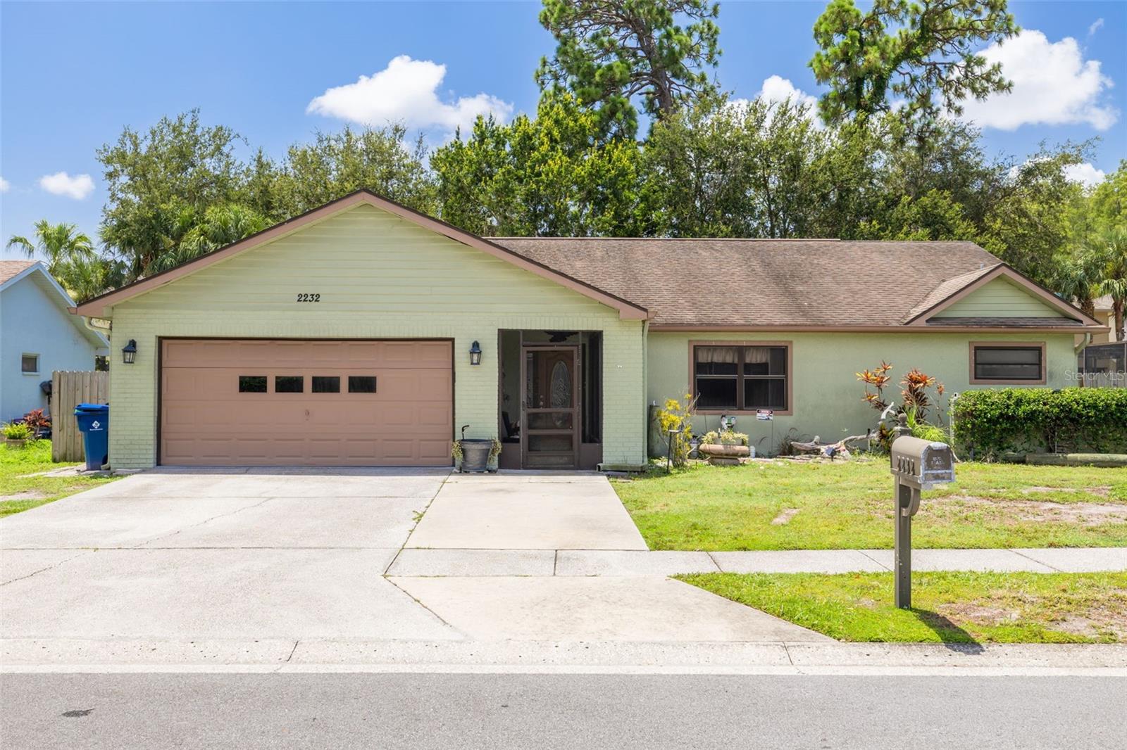 Welcome to a home that just feels right the moment you walk in. Nestled in a quiet Palm Harbor neighborhood on a dead end street. This 4-bedroom, 2-bath split-plan stunner delivers.
Warm wood flooring flows through the heart of the home, paired with vaulted ceilings and anchored by bold 5-inch baseboards that add just the right touch of character. The kitchen is a vibe all its own—featuring solid Corian countertops, a built-in buffet, pendant and recessed lighting, and illuminated display cabinetry that bring both depth and style. It's the perfect setting for everything from casual breakfasts to lively dinner parties.
The wood floors continue into the spacious owner's suite, where French doors open to your private screened lanai. The ensuite is equally refined, with granite countertops, a walk-in closet, and a step-in tiled shower.
On the east wing, you’ll find three additional bedrooms and a full guest bath. Each room offers generous storage and closet space, while the guest bathroom features granite countertops and a soaking tub/shower combo.
Step outside and unwind beneath the custom wood-plank ceiling of your screened lanai. The fully fenced yard offers space to breathe, play, or plant. A paver patio and firepit complete the backyard experience, offering even more space to relax and entertain. With its location in an X flood zone, peace of mind is included. Water Heater(2025), & A/C(2024)
Whether you're upsizing, rightsizing, or planting roots, this home hits all the right notes.