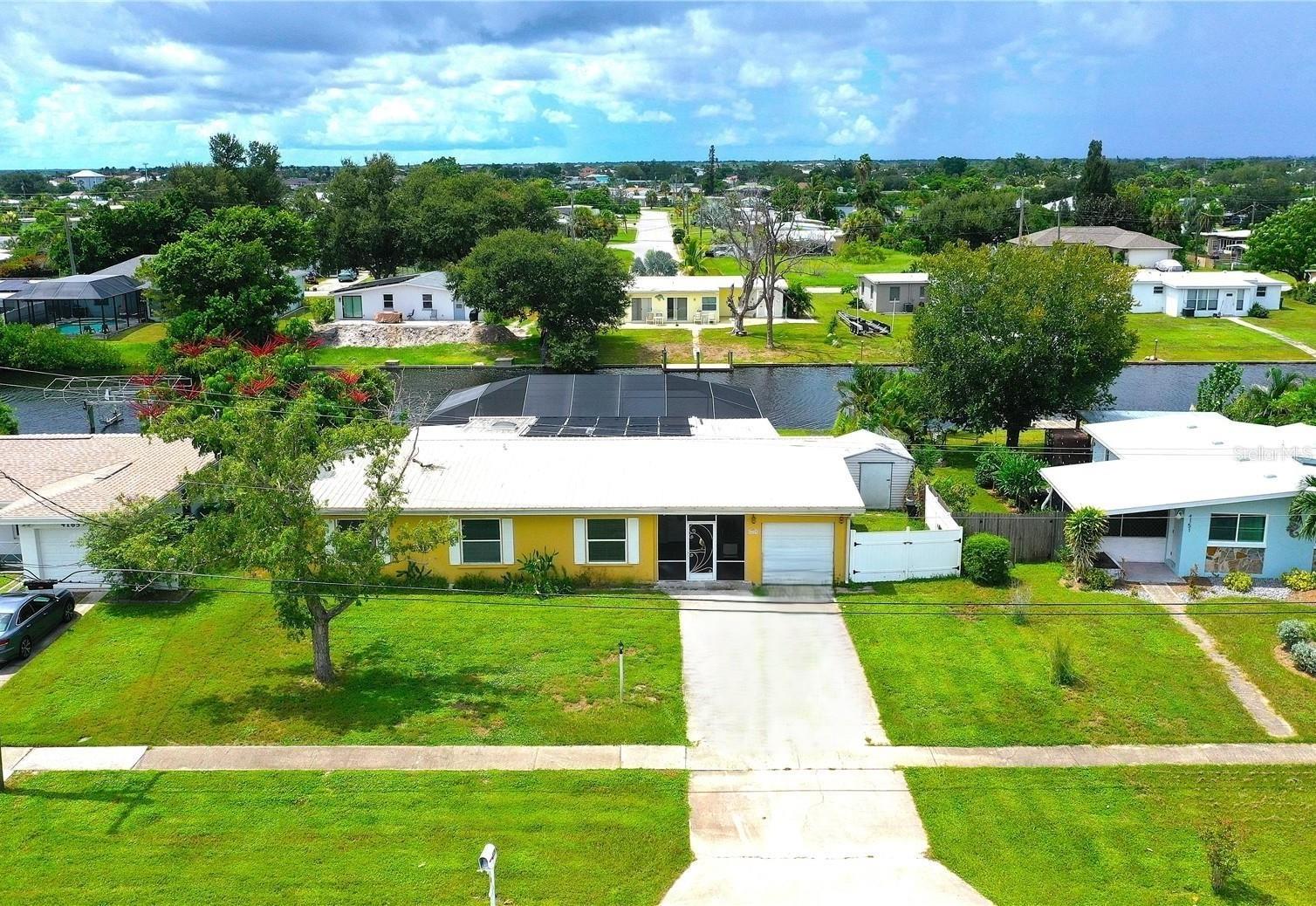 Port Charlotte Florida Waterfront POOL Home with GULF ACCESS! Dive into Florida paradise with this spacious 4-bedroom, 2-bath, 1-car garage home boasting 82 feet of prime canal-frontage! Perfect for boaters, you're just 10 minutes from Charlotte Harbor (one bridge) and a quick ride to the sparkling Gulf waters. Step inside to a bright, open floor plan with a welcoming screened front entry. The living and dining areas flow seamlessly into a modern kitchen featuring sleek cabinets, granite countertops, and a handy built-in desk. With 4 generously sized bedrooms (or use the 4th as a cozy family room) and 2 updated bathrooms, there’s room for everyone—family, friends, or guests! Live the ultimate Florida lifestyle on your screened lanai with brick pavers and a sparkling in-ground pool, perfect for BBQs, morning coffee, or sunset cocktails. At the water’s edge, a concrete seawall awaits your boat. Nestled in a quiet, sidewalk-lined neighborhood with public water/sewer and NO HOA or deed restrictions. Just minutes from Port Charlotte Beach Complex, Sunseeker Resort, historic downtown Punta Gorda, shopping, dining, and all the fun of Charlotte Harbor - boating, world-class fishing, kayaking, golfing, pickleball, farmers markets and beautiful sunsets await! Don’t miss this waterfront home! Schedule your tour TODAY and start living the Gulf Coast life you’ve always wanted!