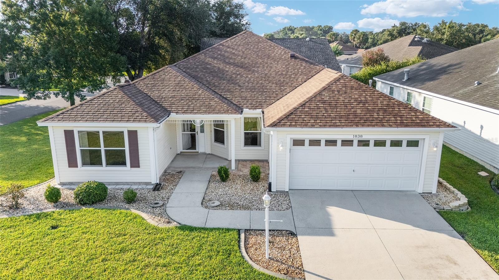 LOCATION, LOCATION, LOCATION!! ** This CAMELLIA DESIGNER MODEL in The Village of Winifred is close to the Winifred Community Pool/Mailboxes, Laurel Manor Regional Recreation Center, GREAT RESTAURANTS & SHOPPING on RT 466, only 2.4 miles from the new COSTCO’S on 466, …. and a SHORT GOLF-CAR RIDE TO Arnold Palmer Legends Country Club & Restaurant, and Lake Sumter Landing Market Square ® !!! – BOND is PAID!! – ROOF = JUNE 2020 -- HVAC 3-TON/14SEER & GAS FURNACE = Sept 2018 -- Gas Water Heater = Oct 2014 -- High & Vaulted Ceilings, Chair Rail & Ceilings Fans!! -- CORNER LOT/CUL-DE-SAC STREET – Easy Maintenance Landscape Beds with Concrete Curbing & Rock Mulch, Gutters & Downspouts, 2-Car Garage – Covered Front Porch with Light, Entry with GLAS STORM DOOR -- Kitchen with STAINLESS STEEL APPLIANCES, Under Cabinet Lighting, Breakfast Bar, PANTRY WITH PULL-OUT SHELVING, Capped Gas-Line for Range – Breakfast Nook with Windows & Chair Rail -- Dining Room & Living Room with Wood Flooring and Glass Slider to Florida Room – The Florida Room has a Ceiling Fan, Sconce Lighting, Tile Flooring with Center Listello Accent Tiles, Acrylic Sliders that allow for lots of Natural Light, and Door to Back PATIO WITH BRICK WALLS -- Primary En Suite with 2 WALK-IN CLOSETS, Bedroom with Windows and Slider to Florida Room, Bathroom with “L-Shaped” Vanity with Make-up Area, Window, Linen Closet, PRIVATE PRIVY WITH STEP-IN SHOWER – the Shower has Bench Seating, Hand-held Sprayer, Grab Bar and Slider Doors!! -- The Guest Wing has a Hall Linen Closet, Bedroom 2 with Ceiling Fan and Closet, Bathroom 2 with Tub/Shower Combo, and Bedroom 3/Den (no closet) with Ceiling Fan and Windows to the Front Yard – Inside Laundry with Utility Sink, Wall Cabinets, Washer & Gas Dryer “Hook-Ups” -- Garage with FREE STANDING STORAGE CABINETS, Pull-down Attic Access Stairs, Irrigation System & Epoxy Floor… BOND HAS BEEN PAID!! – THIS HOME IS LOCATED BETWEEN THE “66’S” -- GREAT LOCATION in The Village of Winifred! DON’T MISS OUT ON THIS GEM OF A HOME!!