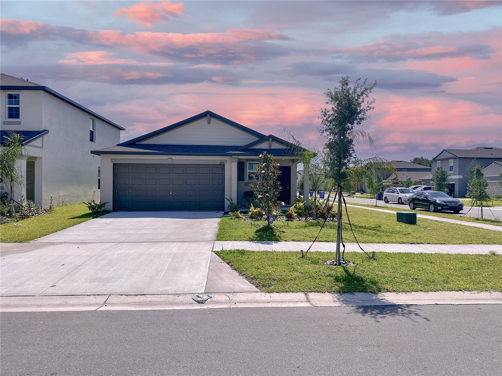 Price improvement makes this gorgeous 3-bedroom, 2-bathroom open-concept home in Berry Bay desirable! It's conveniently located near 301, I-75, schools, shopping and restaurants! Low-maintenance landscaping welcomes you to this 2022-built, beautifully-maintained dream home, and granite countertops supply "wow" factor throughout the SPACIOUS kitchen, which features a large center island, abundant cabinets, ample counter space, garbage disposal, dishwasher, stove, refrigerator/freezer (included) and pantry. Kenetico water softener will stay with the home, too. Convenient to the kitchen, the laundry room, which includes a washer and dryer is near 2nd and 3rd bedrooms. The open-concept living area stays bright with glass sliding doors to the backyard, and the split-plan allows the master suite to be a quiet owner's sanctuary. The second and third bedrooms and full bath provide guest accommodations, work-from-home options or hobby space. Keep cool with ceiling fans throughout and utilize the front door keypad for security. At the community clubhouse, enjoy a resort-style pool, playground, pickleball court, dog park and tot lot! You'll love Florida living in this fabulous home!