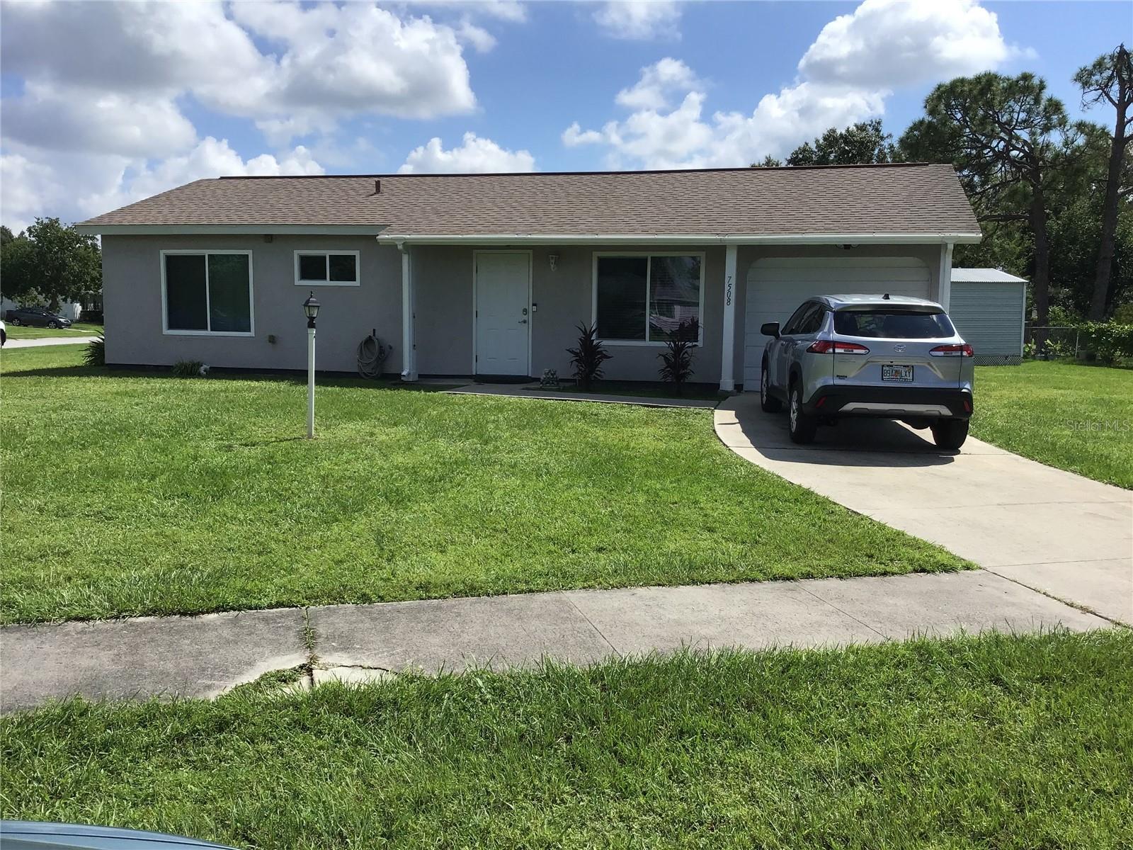 Don't miss this Spacious 2 bedroom home on a HUGE corner lot with city water & sewer in Highland Ridge. Features a Living room & separate Dining room, screen lanai Newer roof, impact windows & newer AC plus updated Kitchen & Bathroom. Kitchen features Pantry,tile back splash, can lights & under cabinet lighting. Shed with electric and security lighting. Home warranty included for the buyer. Call today!