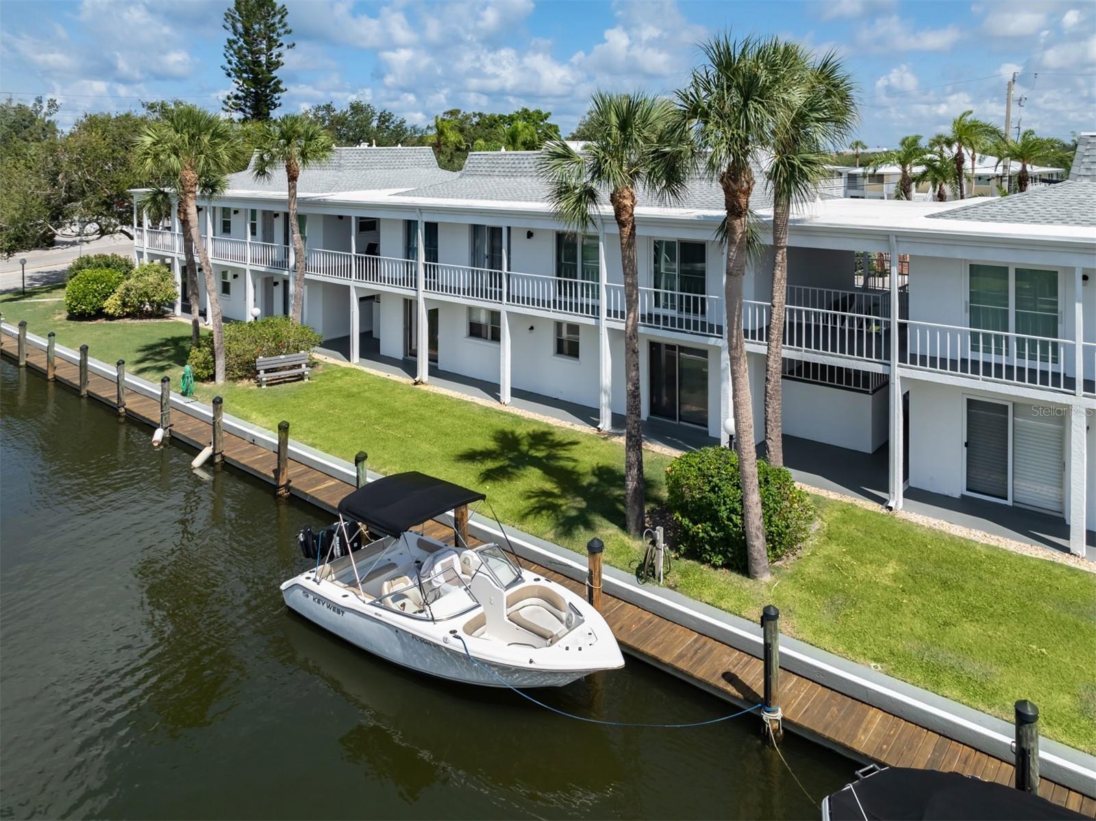 This Venice Island retreat presents a dream come true for those who envision paradise. Ideally in the Bahia Vista Gulf community, this two-bedroom, two-bath first-floor condominium harmonizes waterfront living with luxurious amenities. The interior has undergone extensive renovation featuring a well thought out floor plan replete with beautiful finishes. Bathed in natural light, the living room features sliding new hurricane impact doors that overlook the canal and boat slips. Fit for a chef, the kitchen features solid countertops, fresh white cabinetry and new stainless steel appliances. Luxury vinyl flooring, a crisp coat of paint and remodeled baths with new vanities, tiled showers, mirrors and fixtures complete the upscale design. Offered turnkey furnished, this move-in ready home is ideal as a seasonal escape, a full-time getaway or a rental property with income potential. For sun seekers, the community offers private beach access to the Gulf of Mexico, as well as a pool area for tranquil rest and relaxation. The boating enthusiast will appreciate the boat slips, which are available on a first-come, first-served basis. Unit 171 is ideally located just steps from your assigned parking space to your brand new impact door. In addition, each residence comes with a storage unit and ample guest parking. With proximity to dining, shopping, the Venice Jetty and the esteemed Venice Yacht Club, your tropical bliss awaits in Bahia Vista Gulf.
